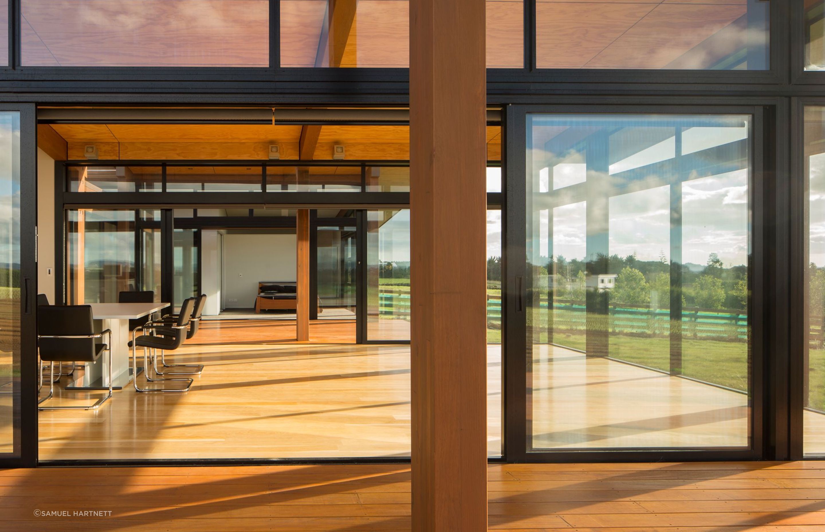 Two pavilions are linked by extensive decking and extensive glazing.