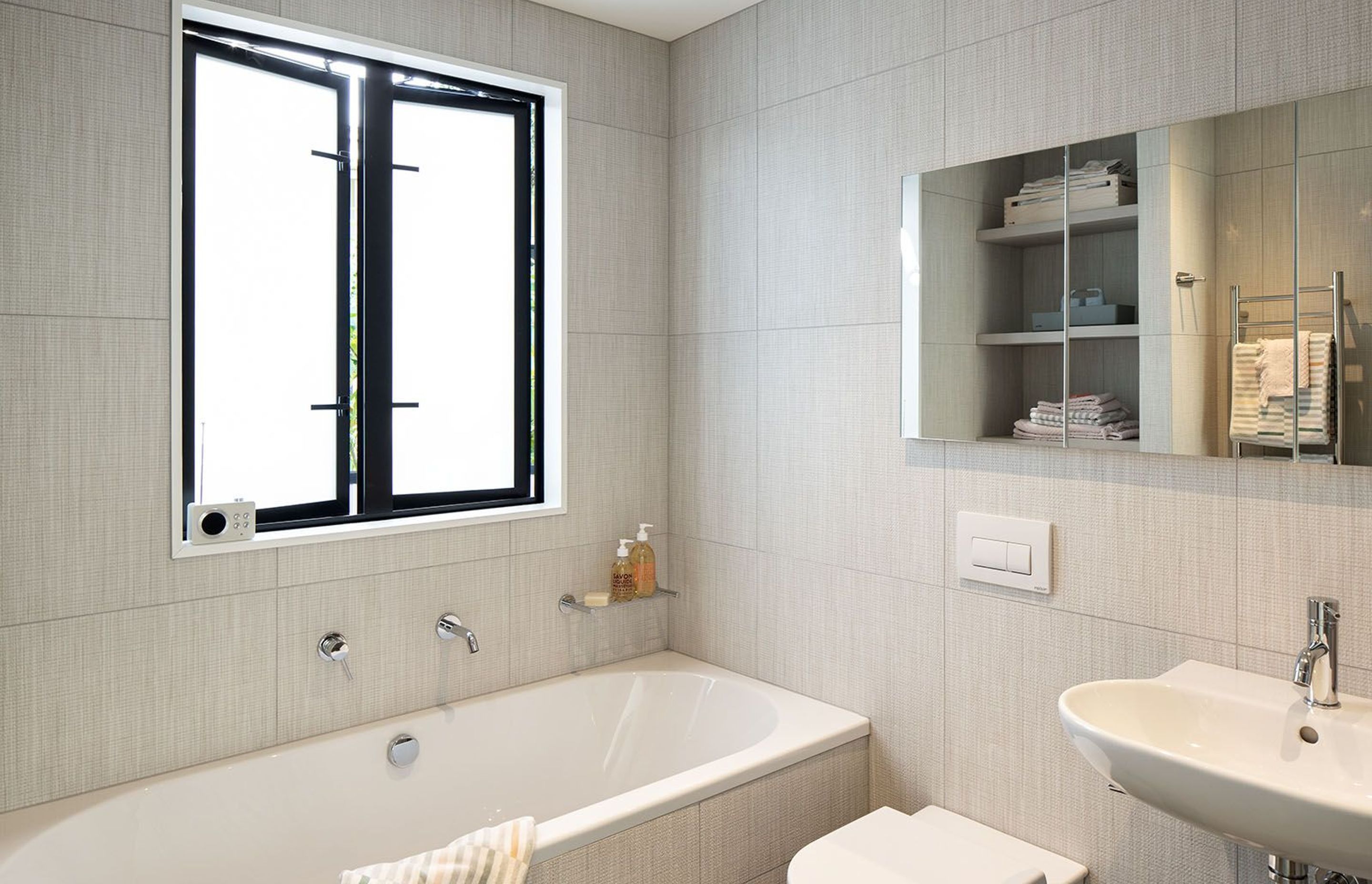 A classic bathroom features textural linen-look tiles.