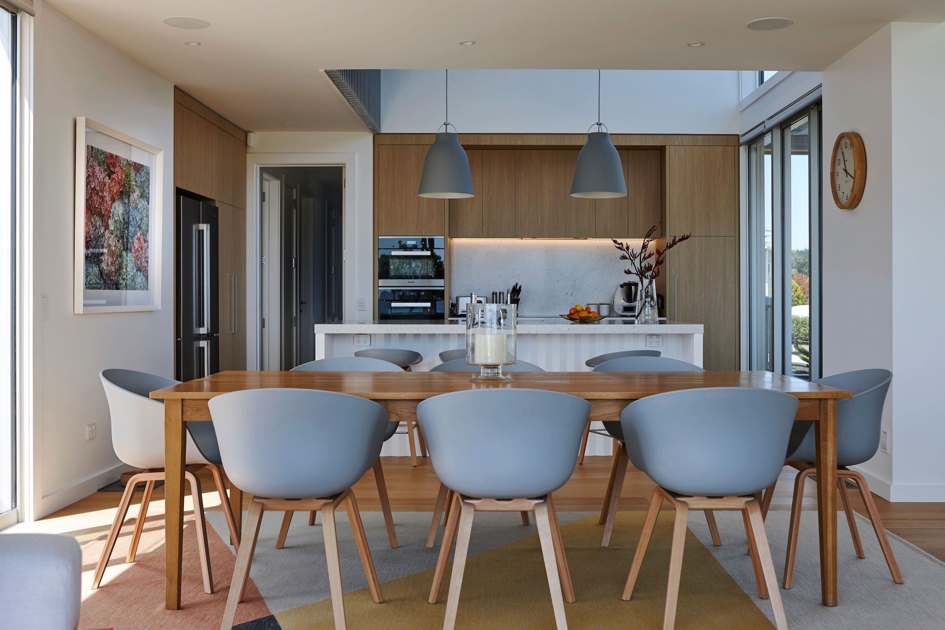 In the kitchen, Caravaggio pendants and Hay dining chairs and bar stools are from Cult.