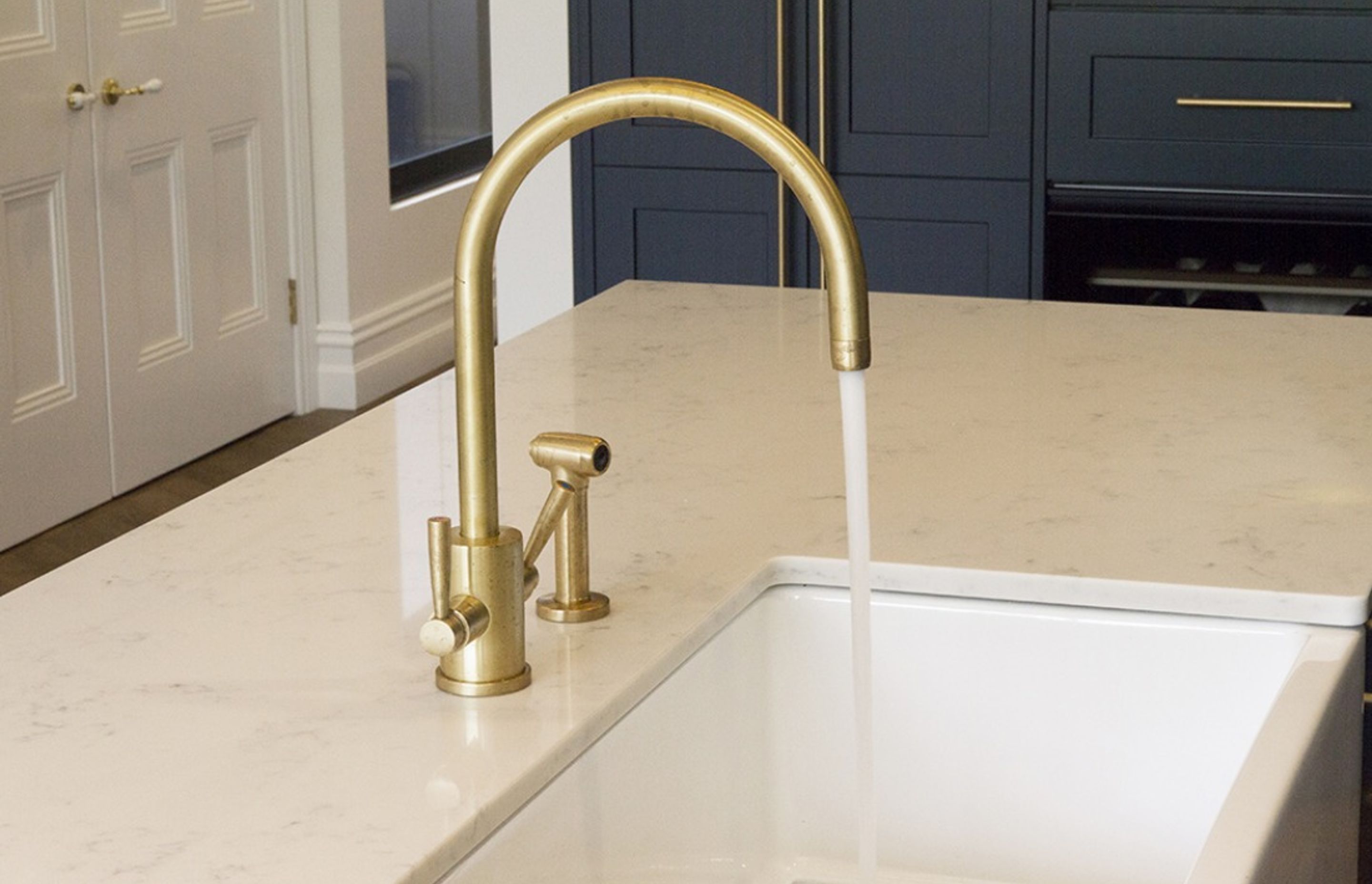 The Orbiq kitchen tap with spray rinse. All tapware can be supplied in Satin or Polished Brass or electroplated in a choice of finish.