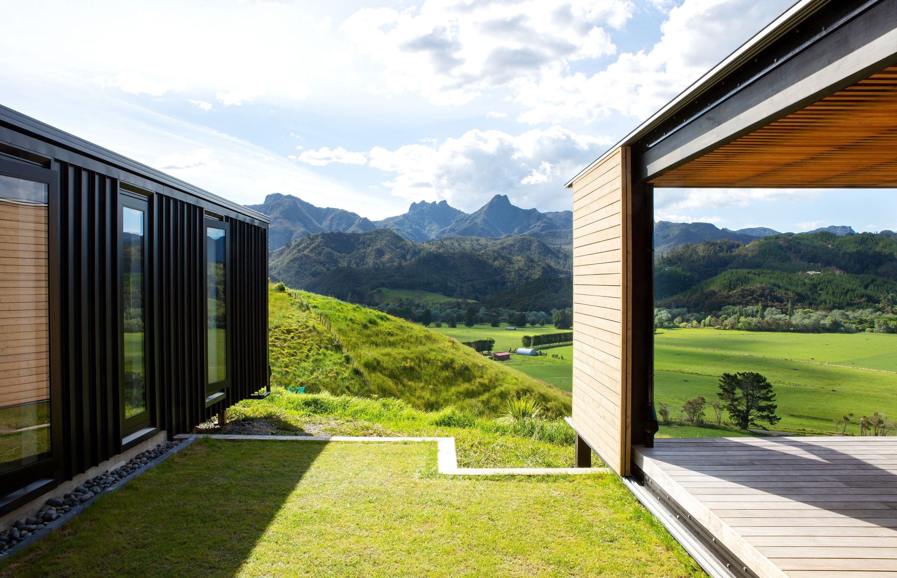 A sliding door clad in larch was envisioned as a barn-style door, designed to move across both outdoor area and lounge wall to provide a versatile level of shelter as required.