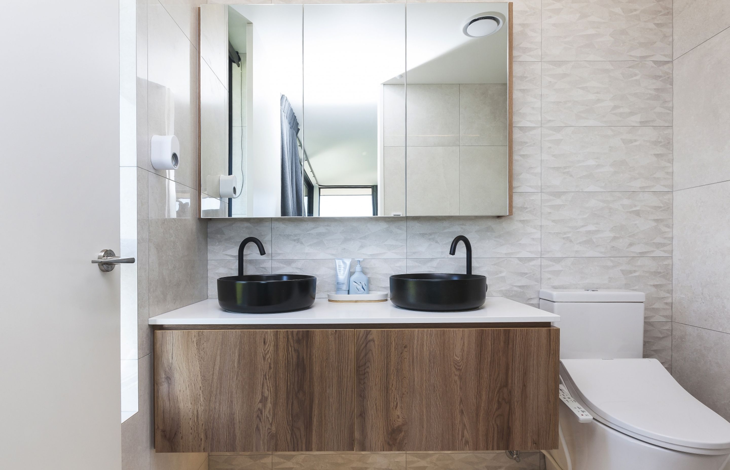 Texture and contrast can be found in the main ensuite bathroom, which features design elements from throughout the home.