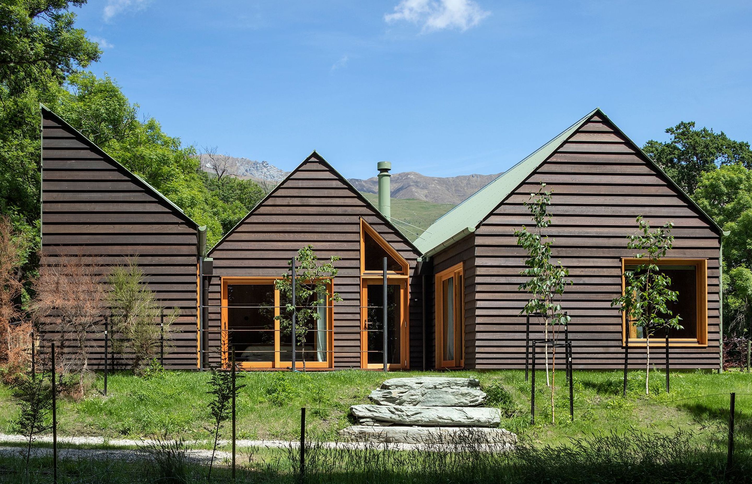 Two gable roof forms and a half gable make up the composition of Wanaka Crib, mimicking the jagged mountain rages in behind. All photography by Simon Devitt.