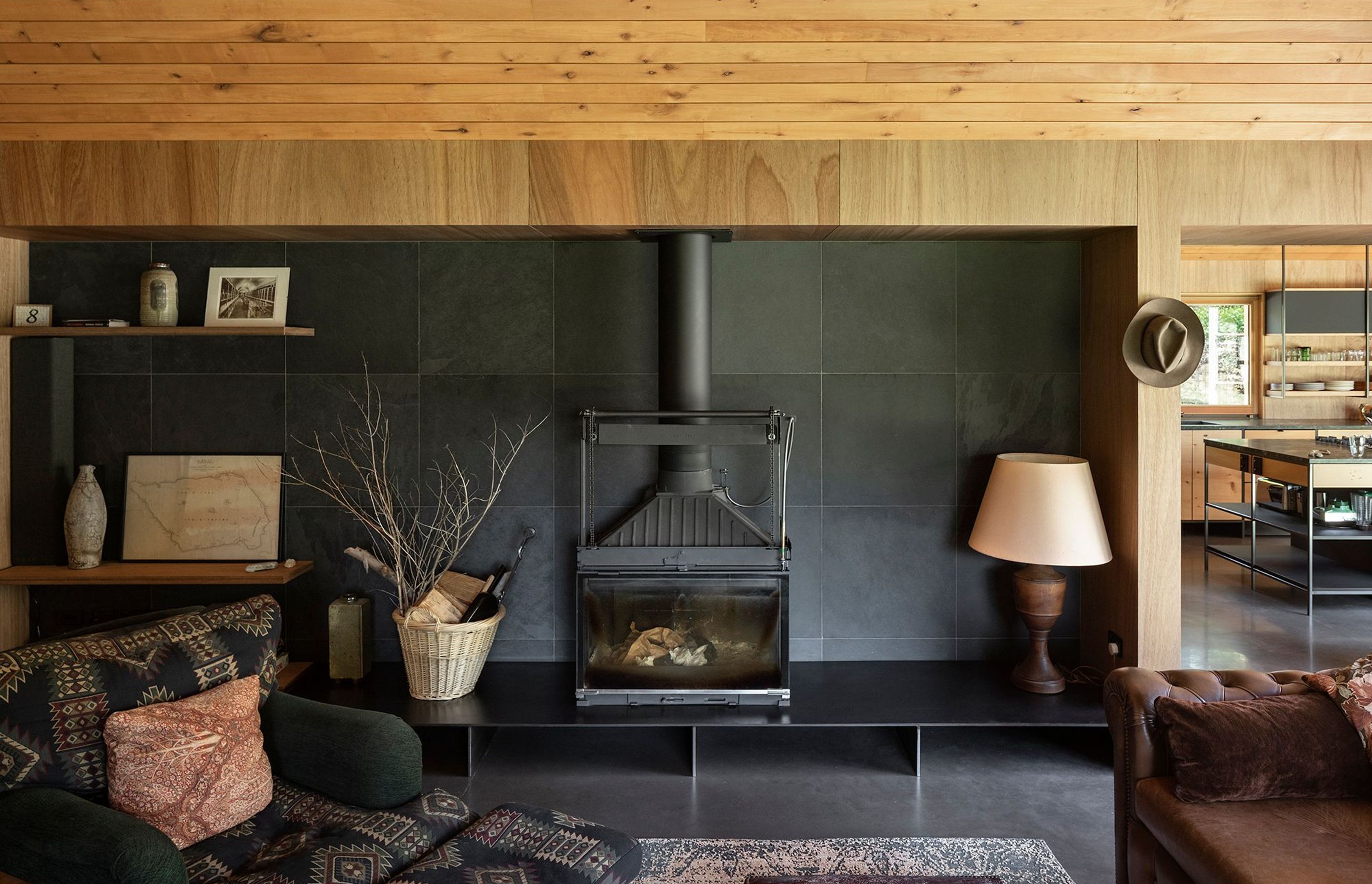 'A bit Steampunk', the inner workings of the fireplace are exposed and unfinished. Granite tiles, Tasmanian blackwood ply walls and southern silver beech ceilings complete the look.