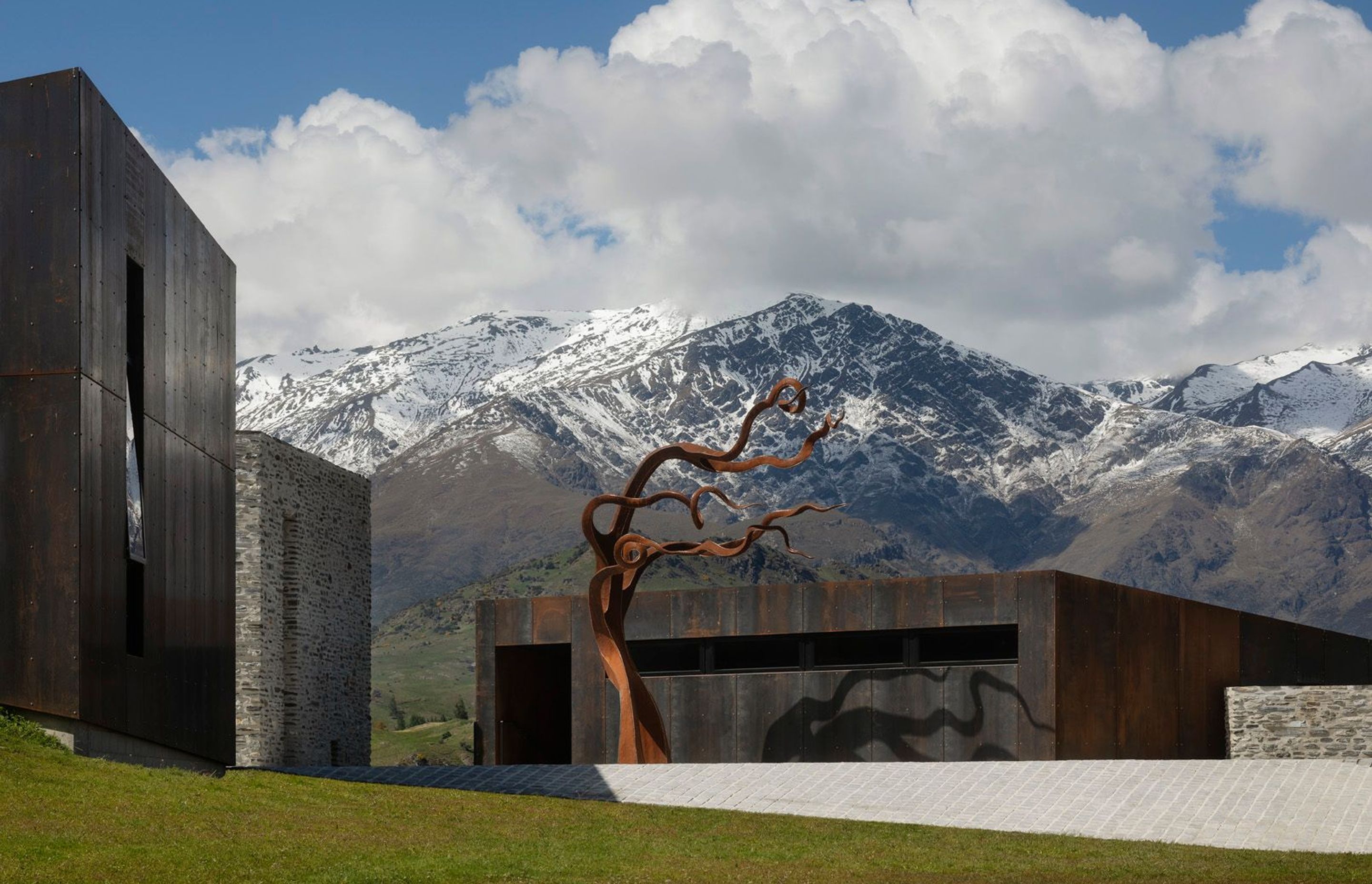Within this mountainous backdrop, the owner's Corten steel sculpture holds its own as a central focus of the central courtyard.