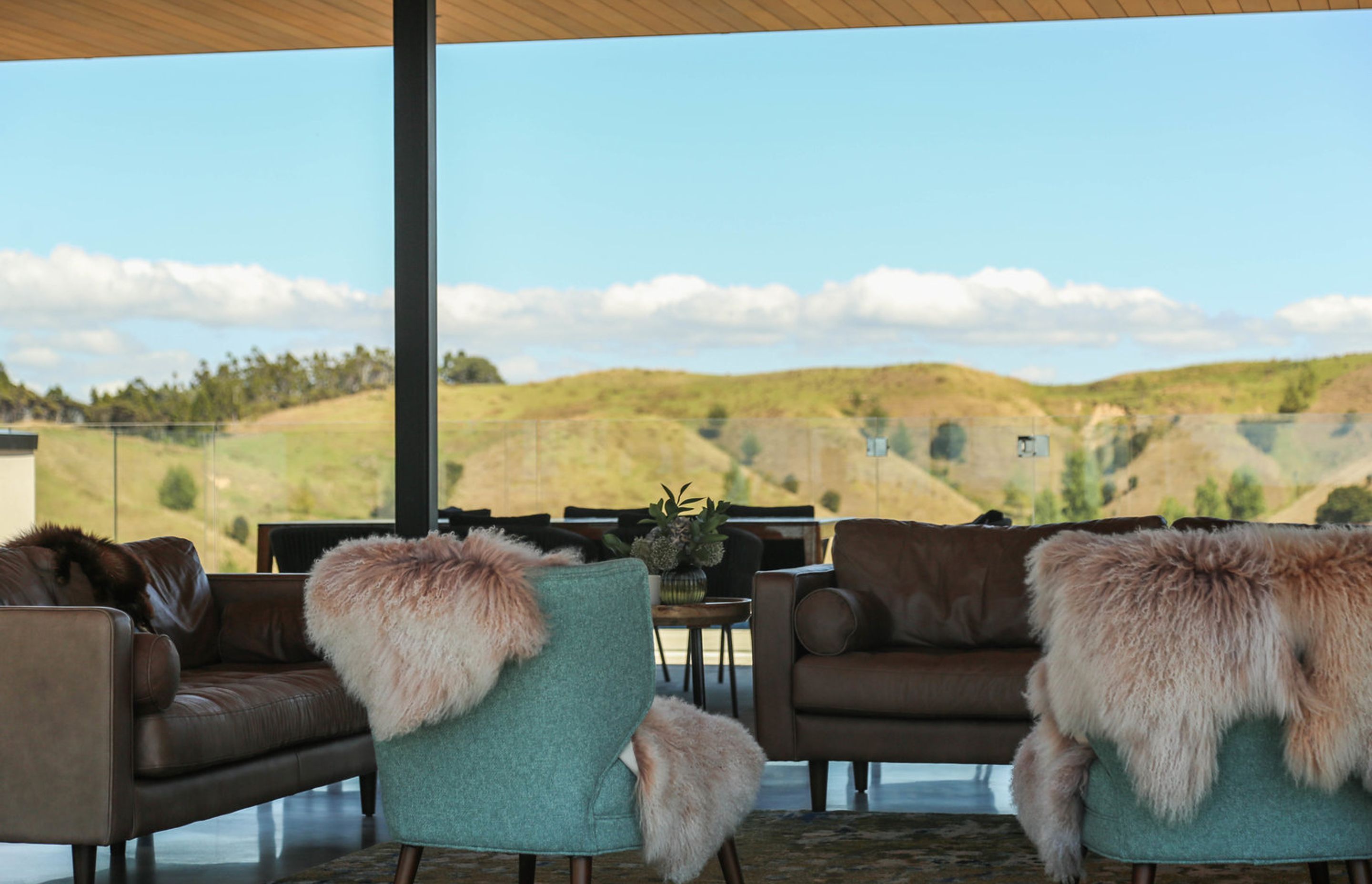 The cosy lounge area with a hillside backdrop.