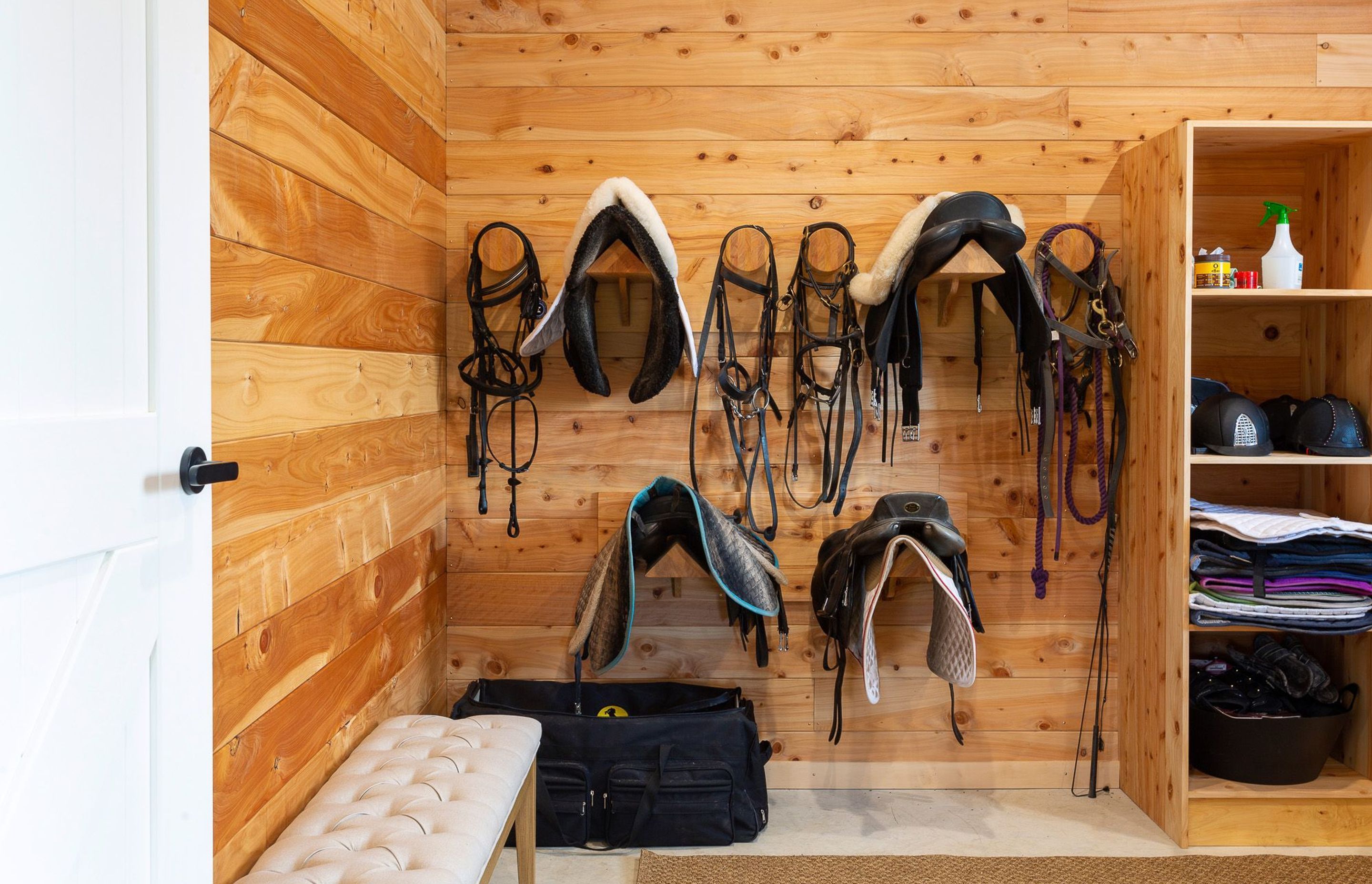 The separate tack room features custom made joinery for housing specialist equestrine gear. 