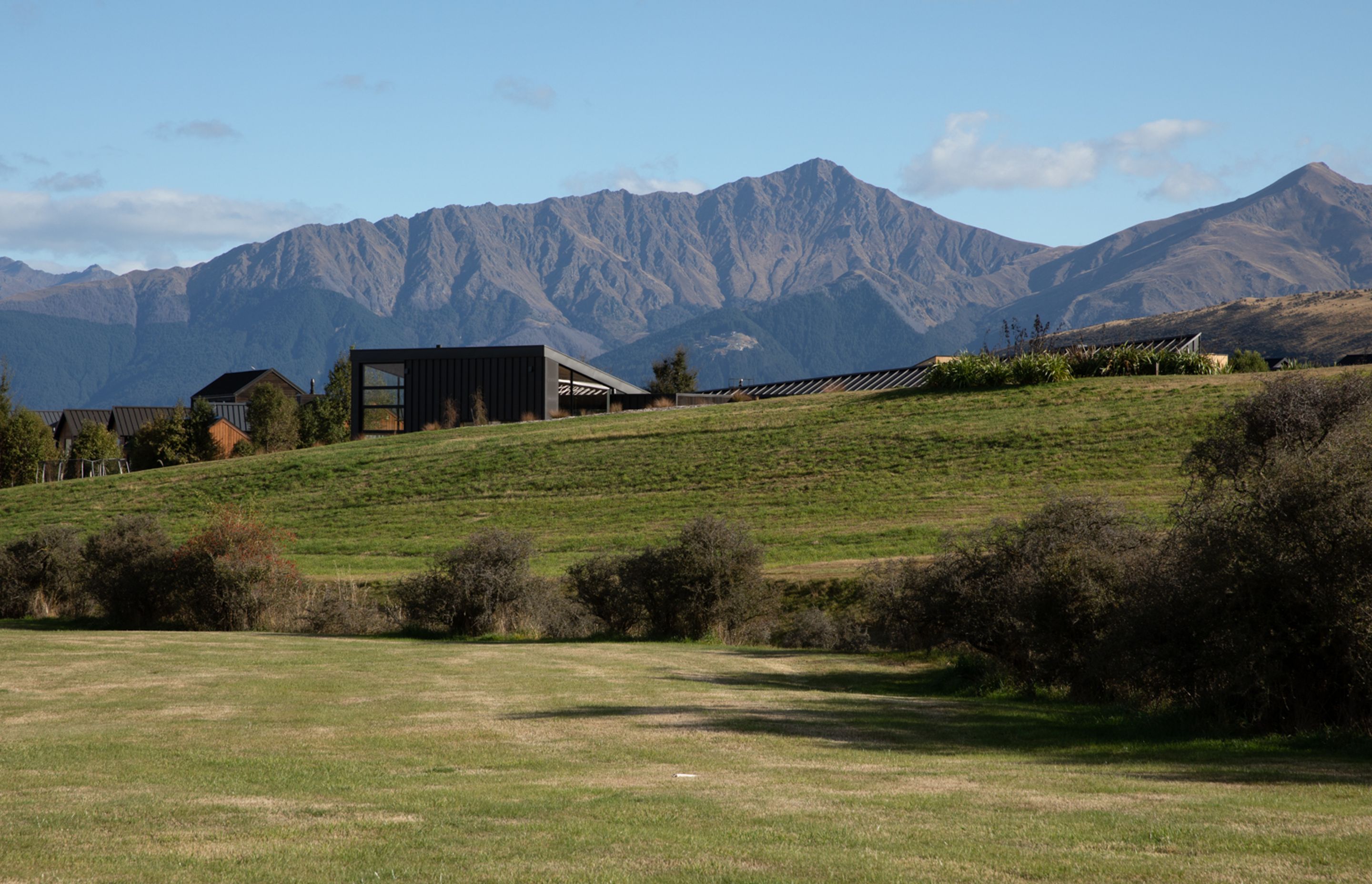 Located at the entrance of Jack's Point, Queenstown, Hill House is surrounded by mountain ranges.