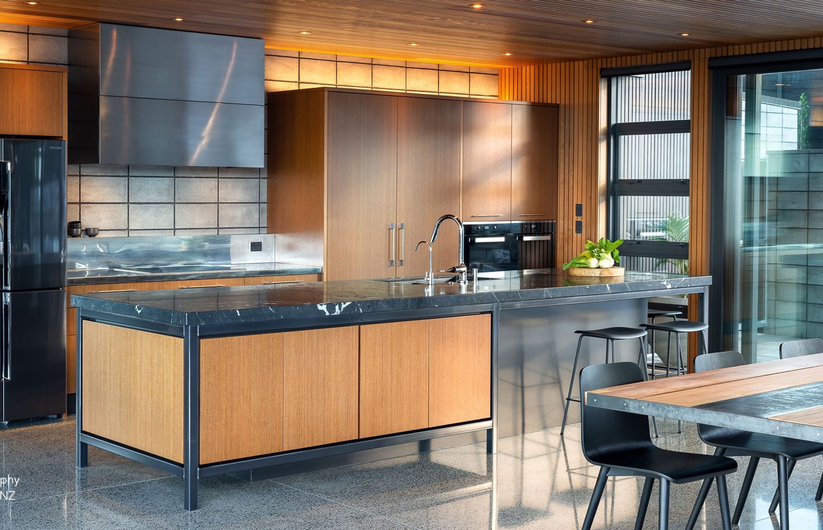 Zones have been created throughout the kitchen to keep the flow and ergonomics at its prime, while the front of the island conveniently houses drinks and homework resources.
