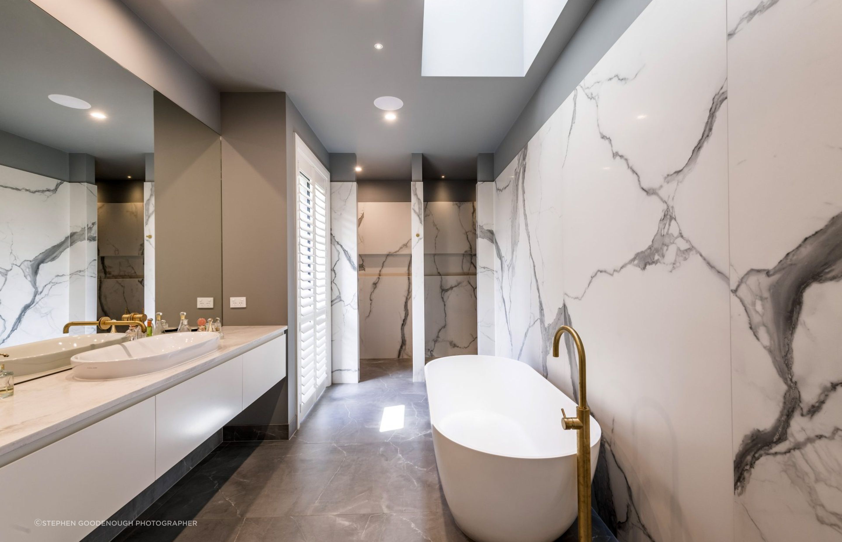 Large-format marble-veined tiling is a feature of this sumptuous bathroom.