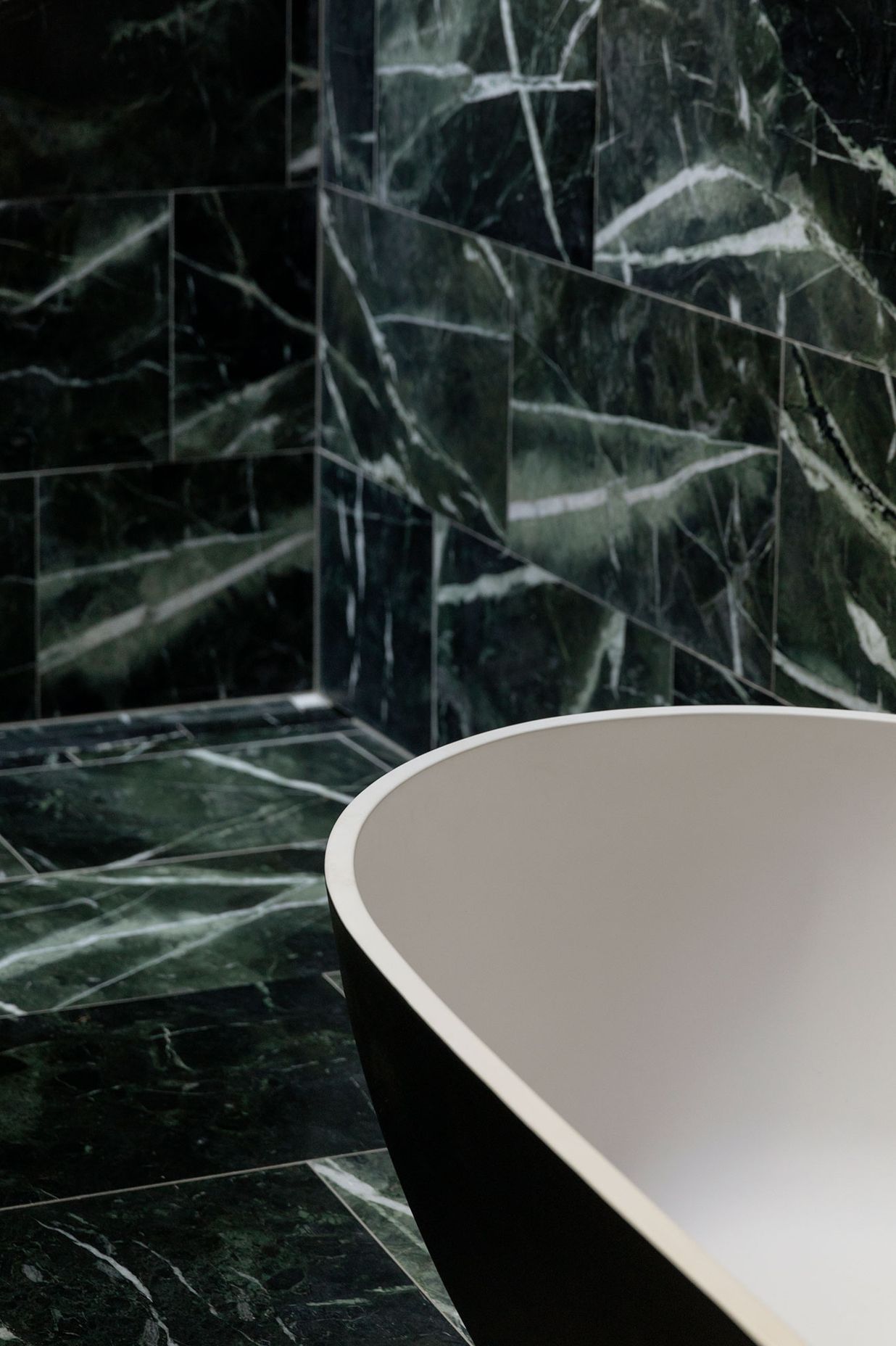 The ensuite bathroom is lined in marble.