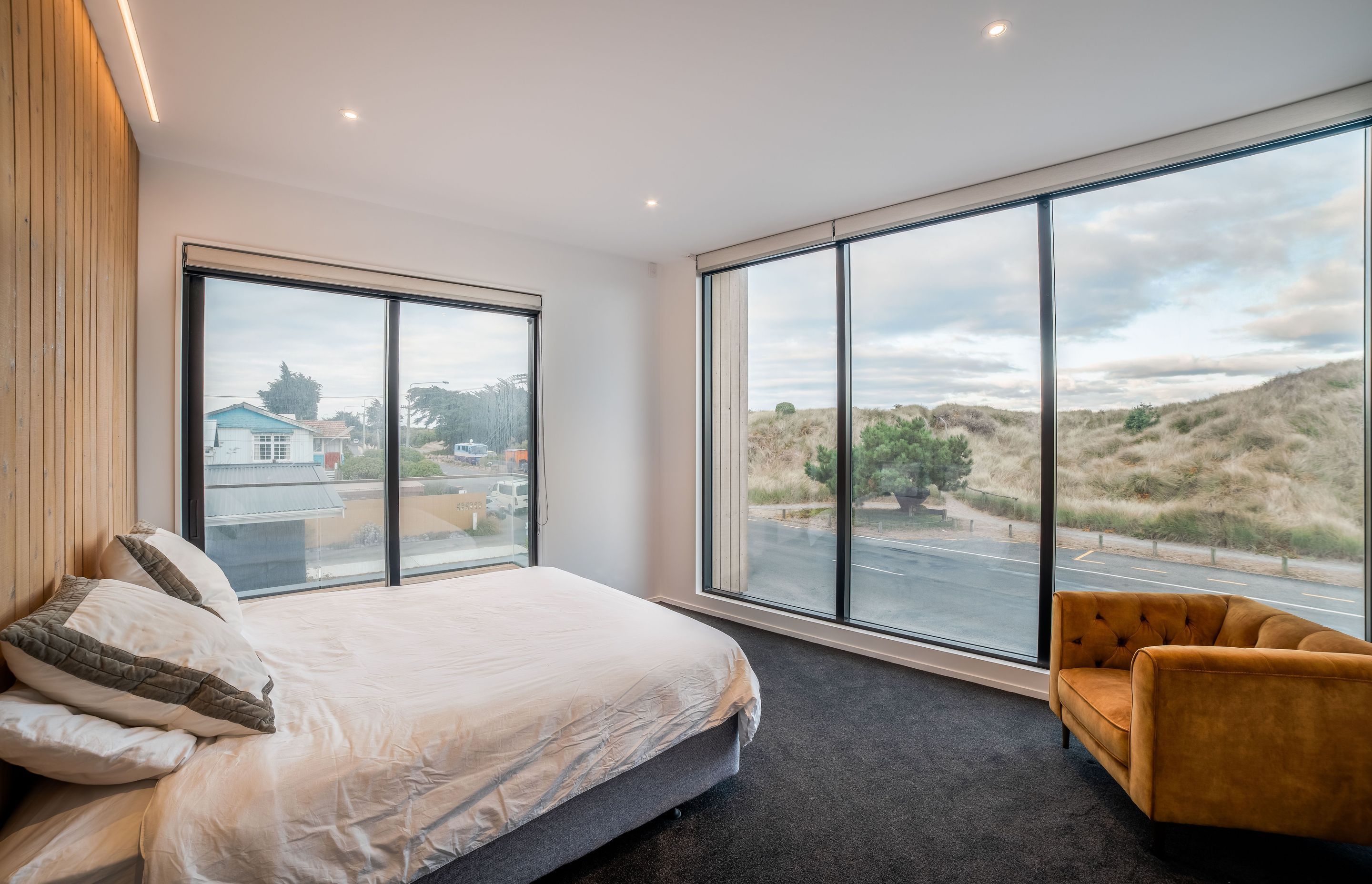 Full height glazing in the master bedroom affords views across to the dunes. 