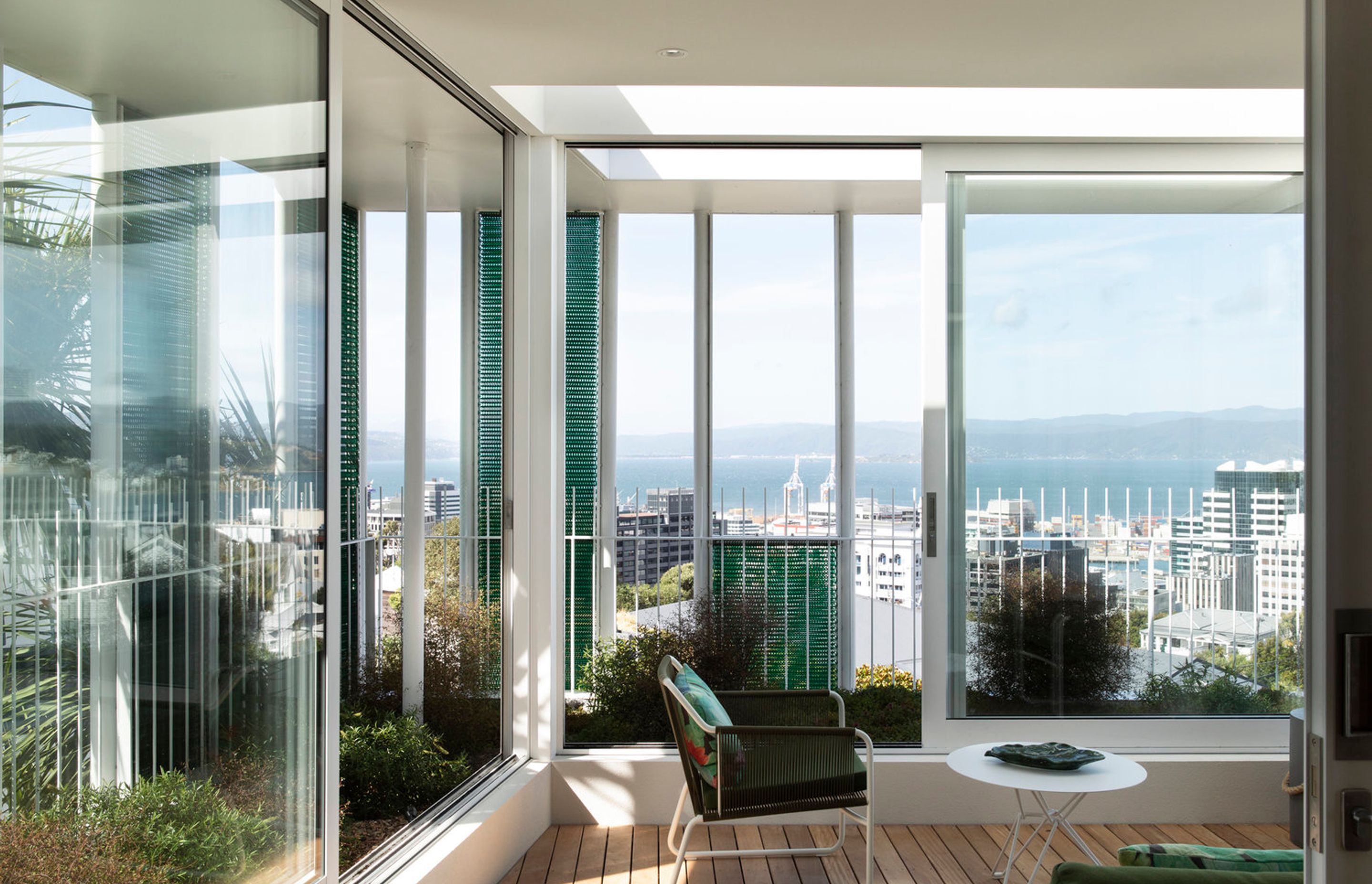 The winter garden in the upstairs apartment features sliding doors that open the interior up to the spectacular view of Wellington harbour and city.
