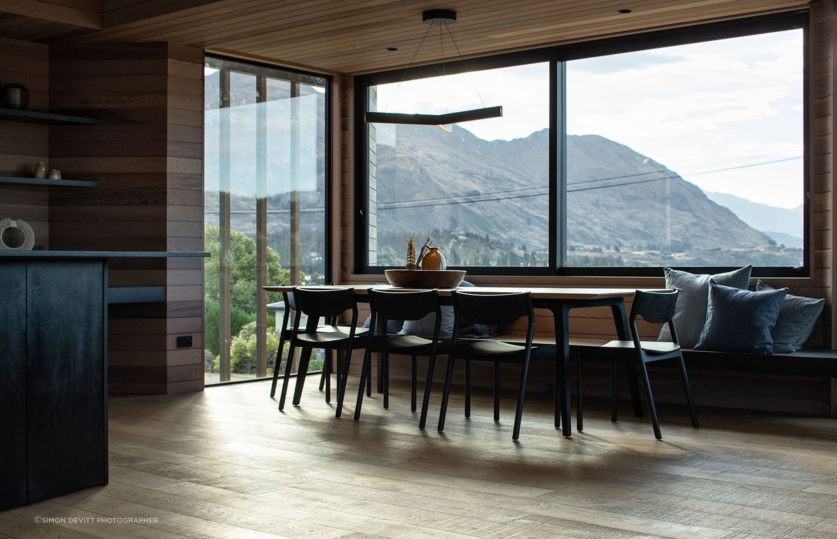 The dining area enjoys dynamic views over the lake and mountain ranges.