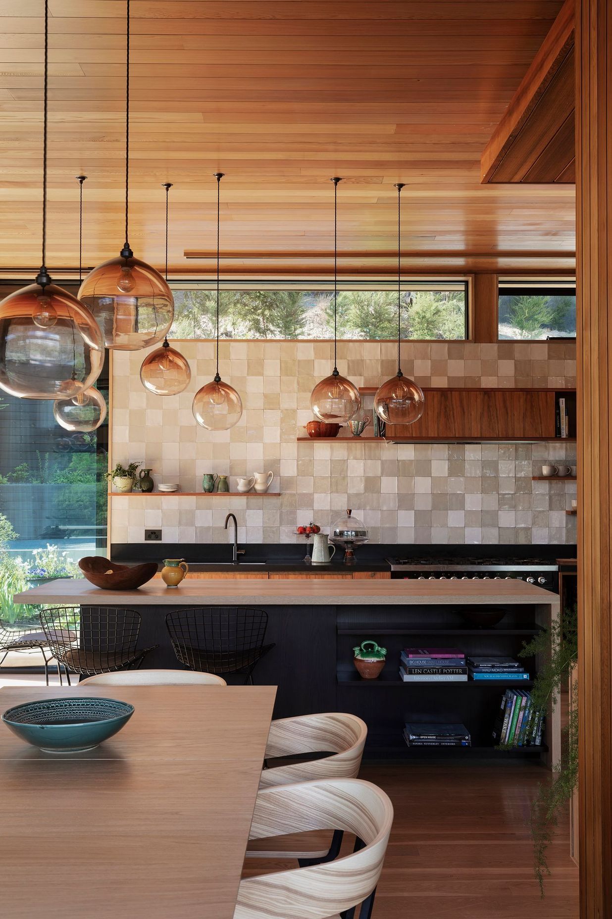 Handblown pendent lights speckle the open-plan living space and tie it together.