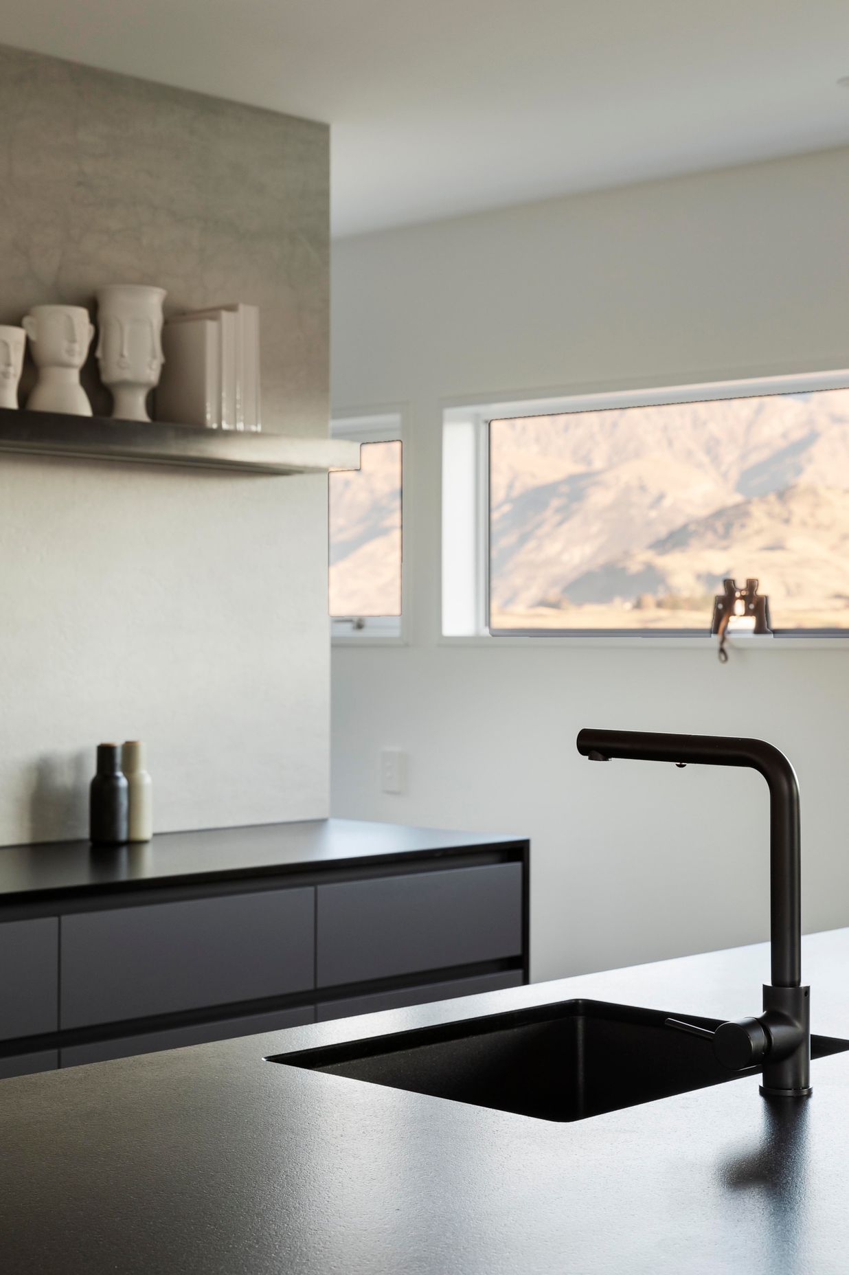 A slot window that runs along the kitchen wall at head height, captures The Remarkables perfectly.