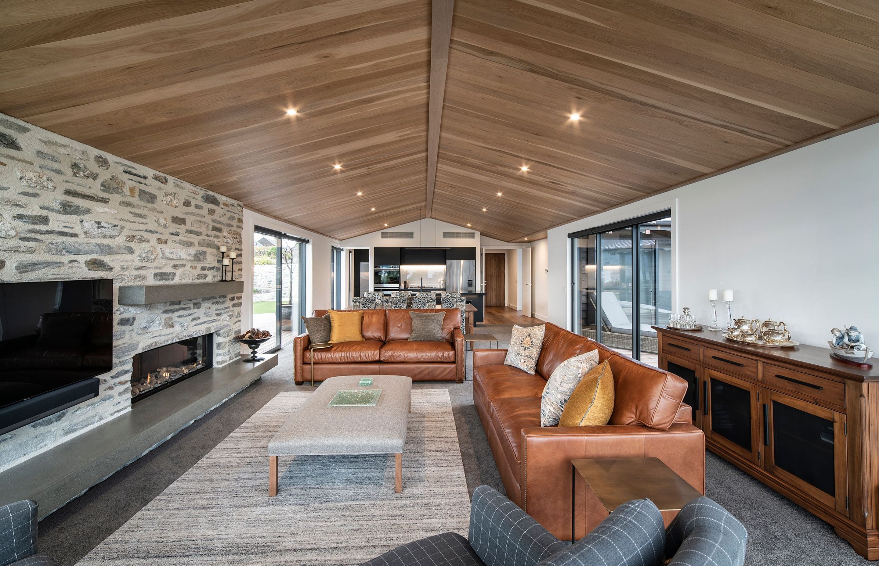 The main living area is contained within one of the two pavilion-style structures that make up the public and private spaces of the home. Off either side of the living area are multiple outdoor zones for further entertaining.