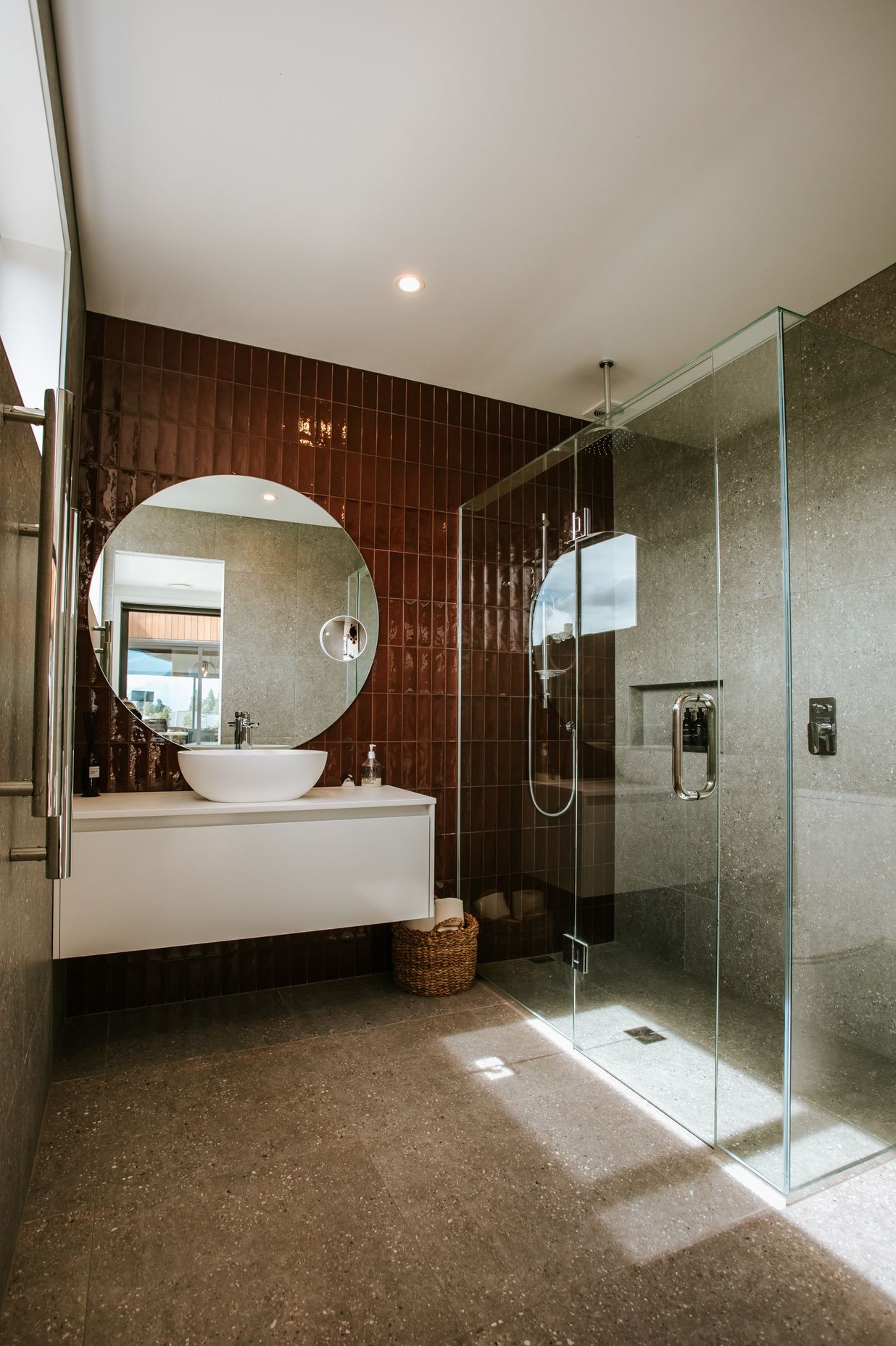 The fully tiled bathroom is a luxurious and sleek haven.