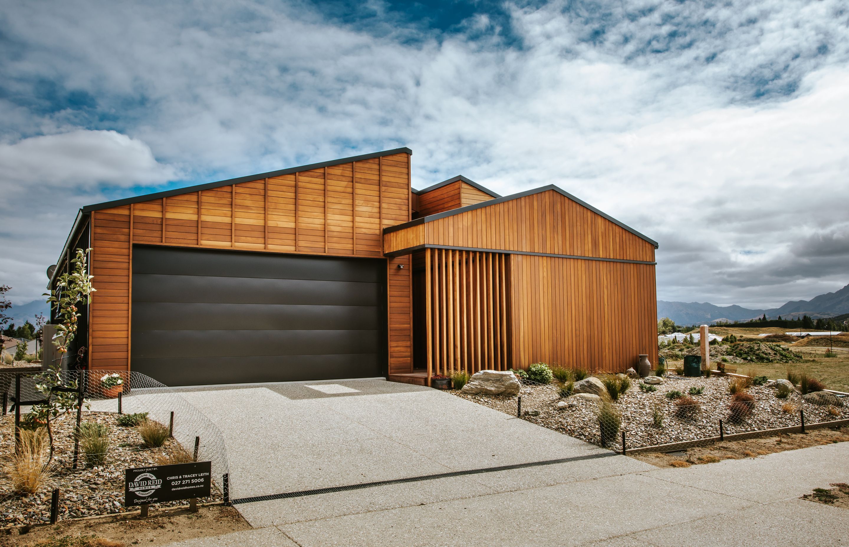 The road-facing elevation features Truwood cladding in varying horizontal, vertical and battened formations.