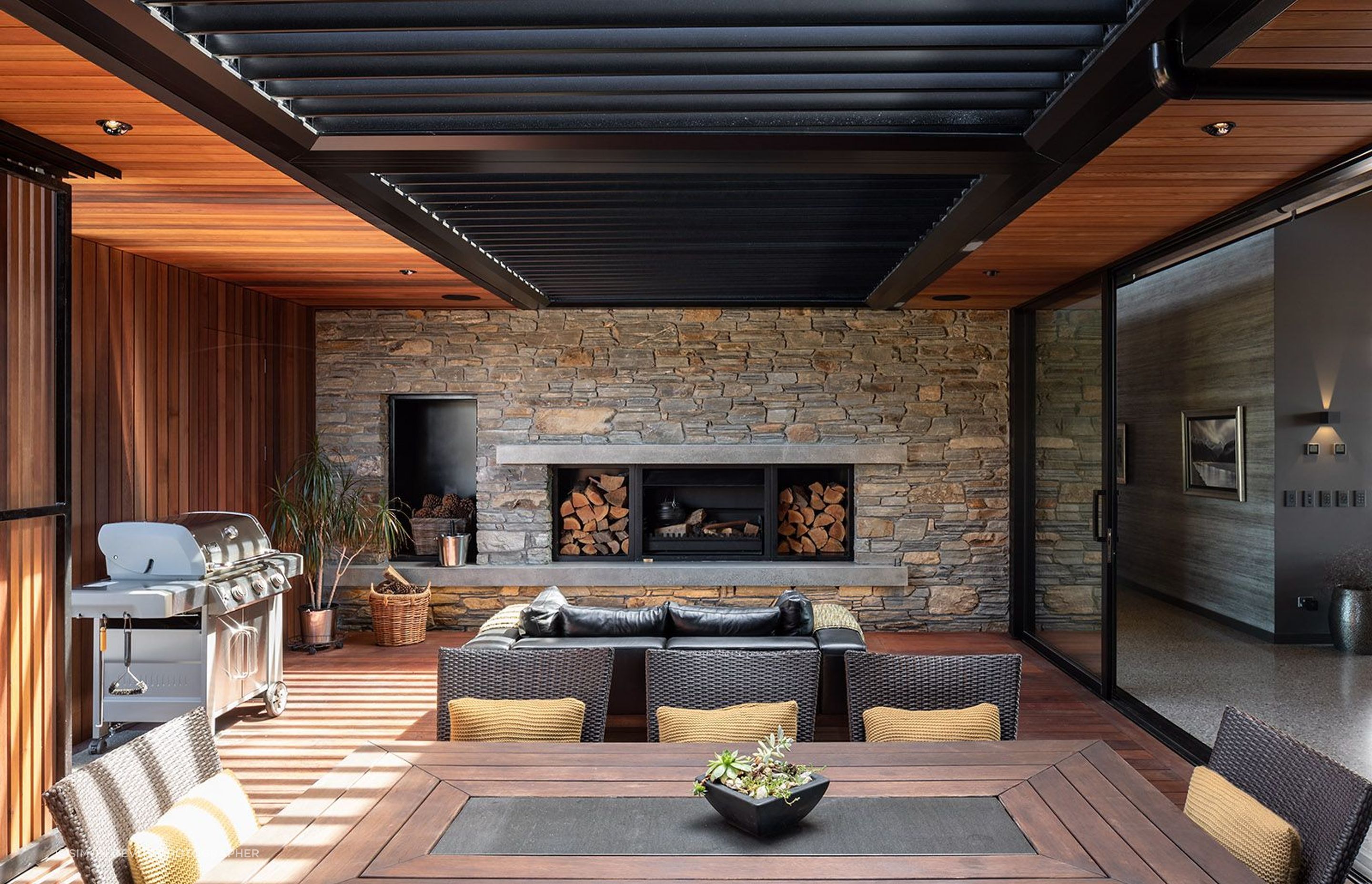 The courtyard at the back of the living spaces features moveable cedar screens that filter light into the cosy space.