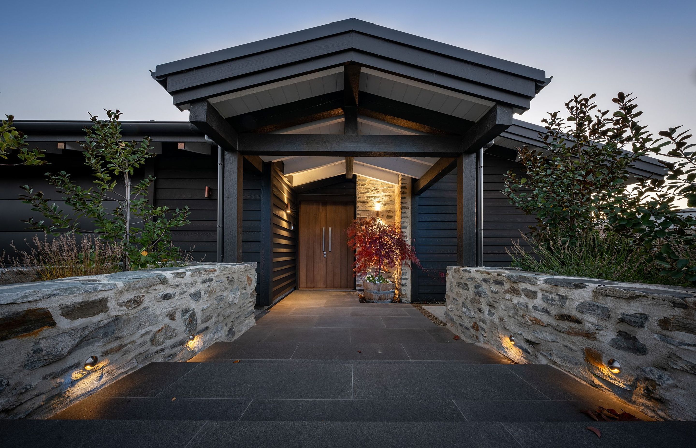 Dramatic in its colour scheme and bold materials, the solidity of the front of this home belies its almost total openness beyond the front door.
