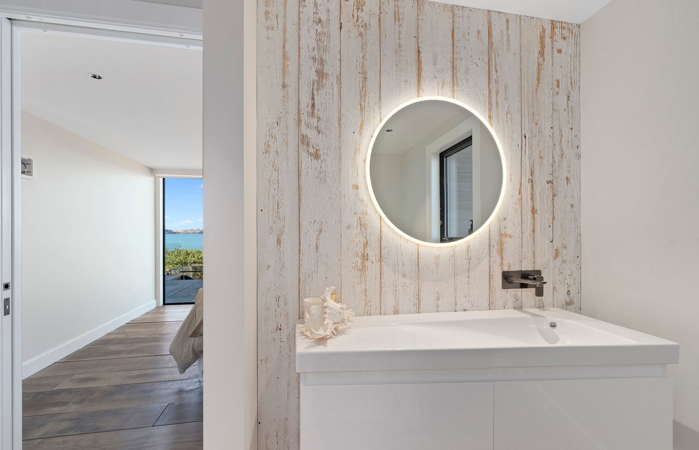 Recycled Canadian barn weatherboards were whitewashed and used as accent pieces in the bathroom and main bedroom.