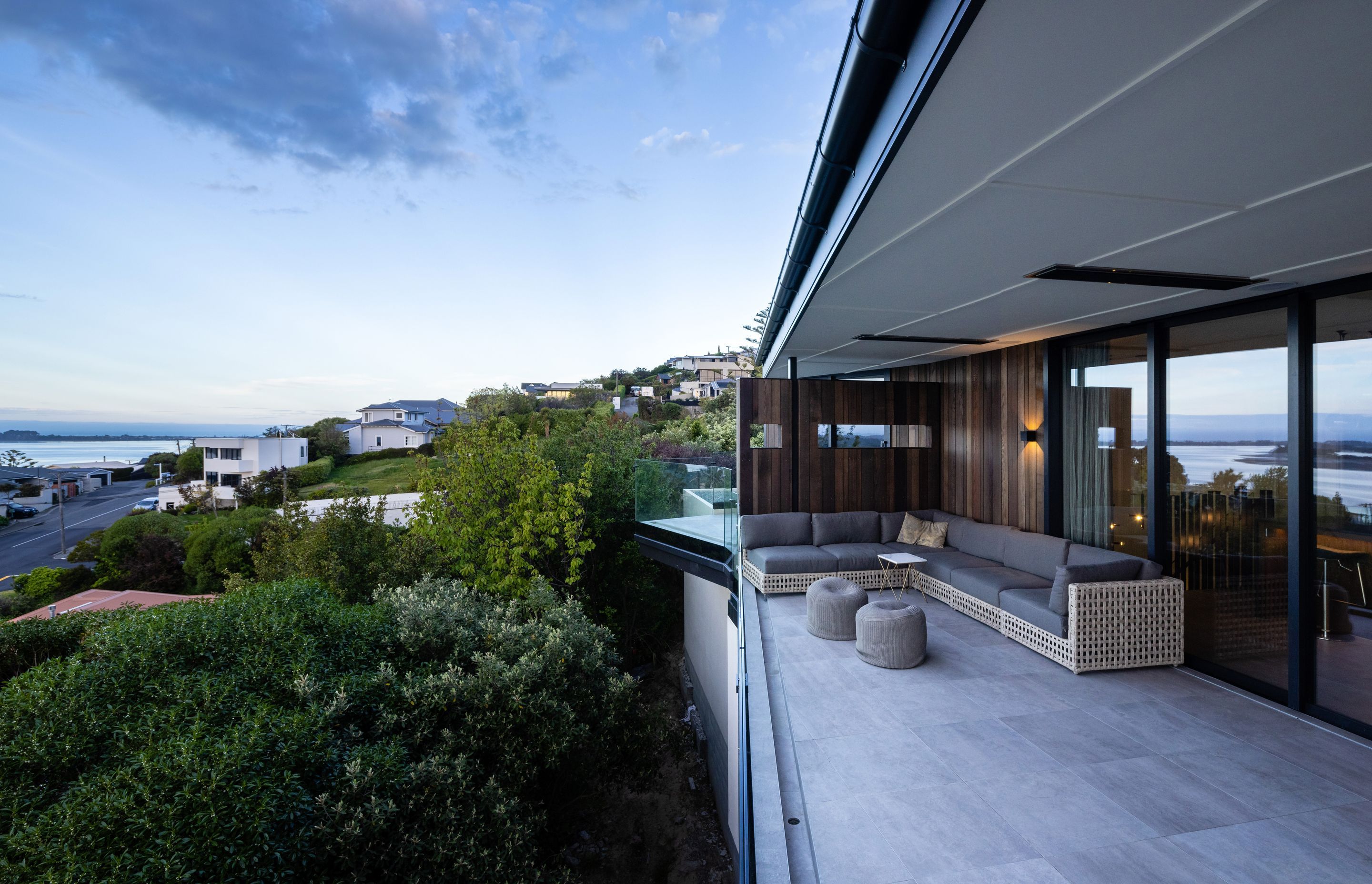 A cedar clad dividing wall, separates the master bedroom balcony from the outdoor entertainment space.