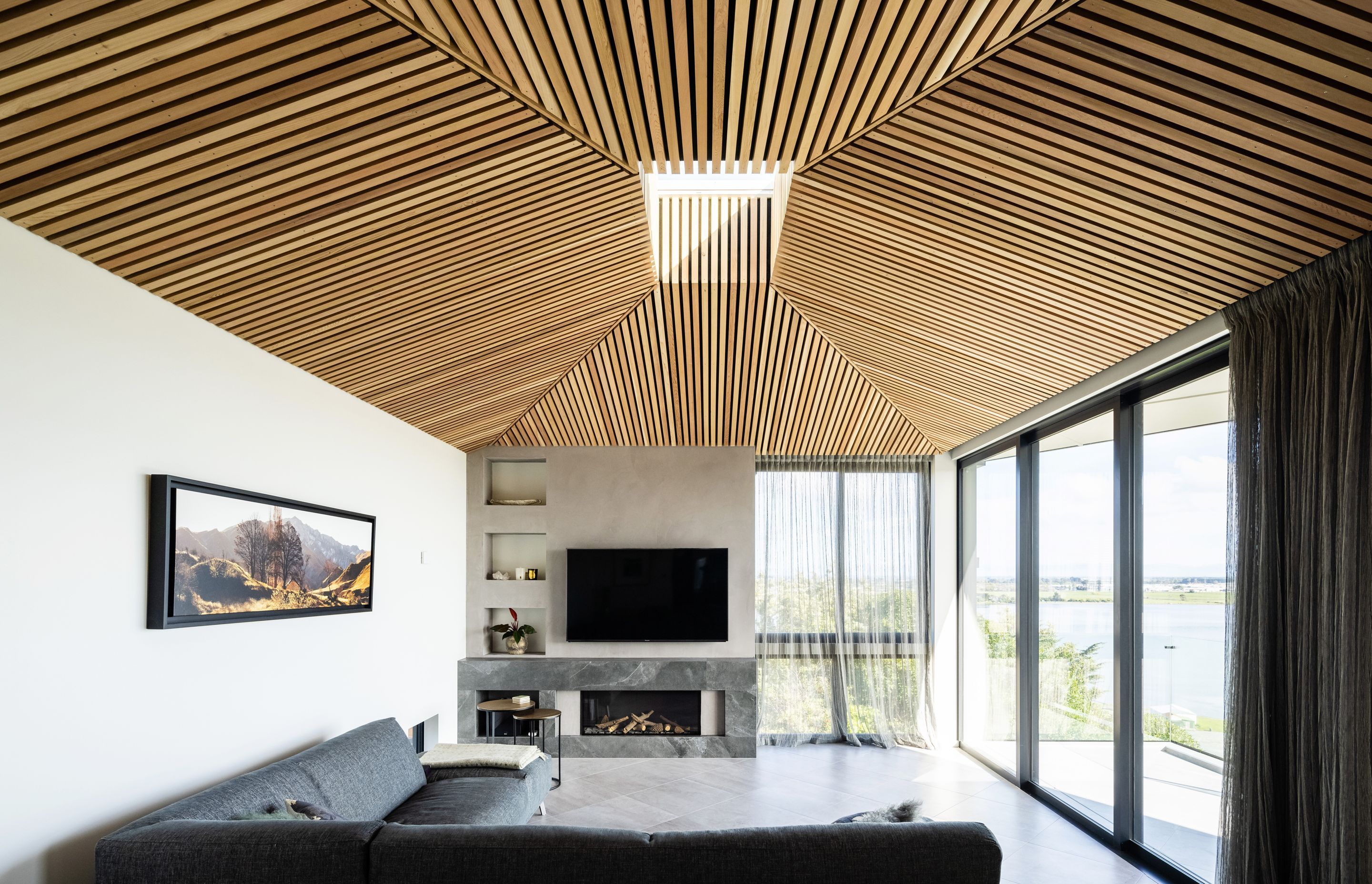 The battened cedar ceiling soars towards a central operable skylight.