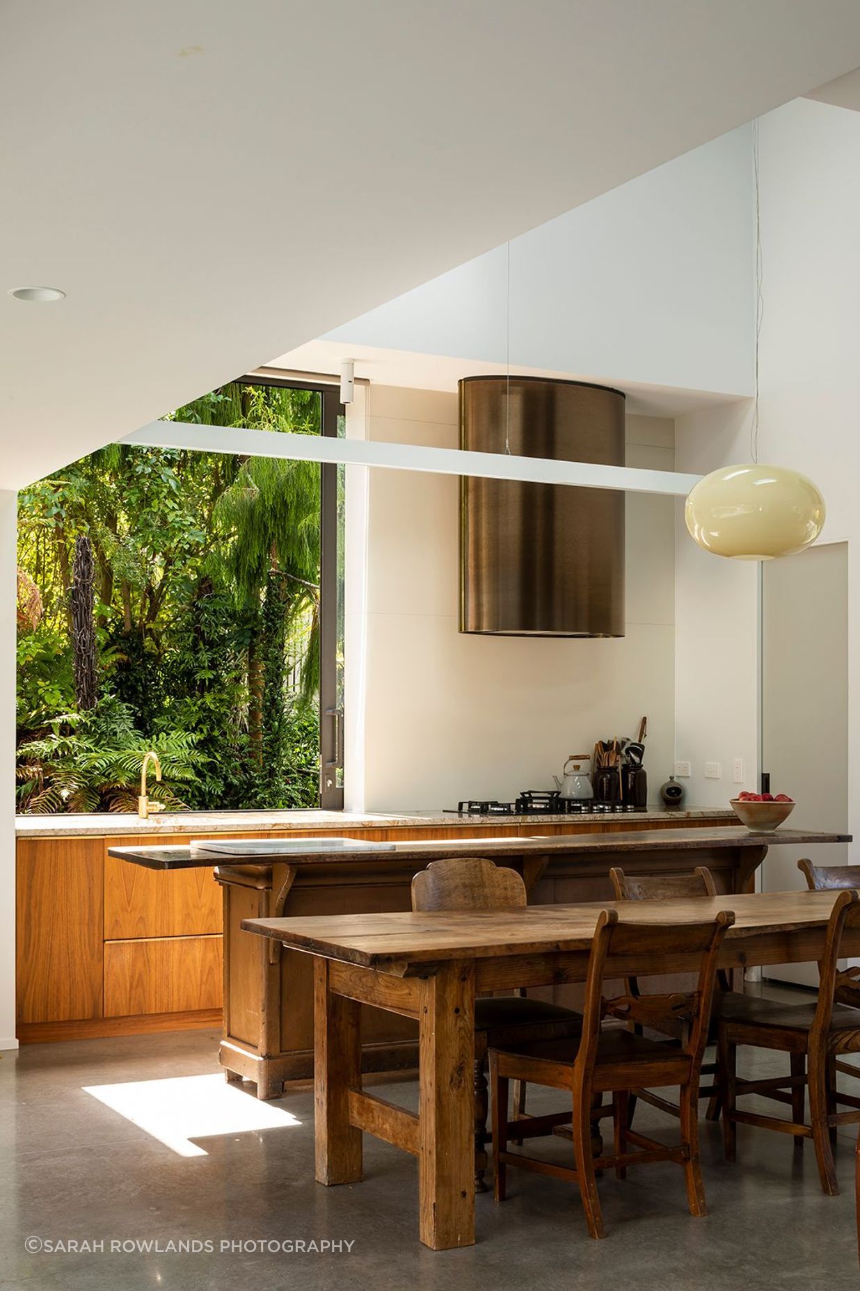 The large sliding kitchen window gives a jaw-dropping picture view to the native bush reserve.