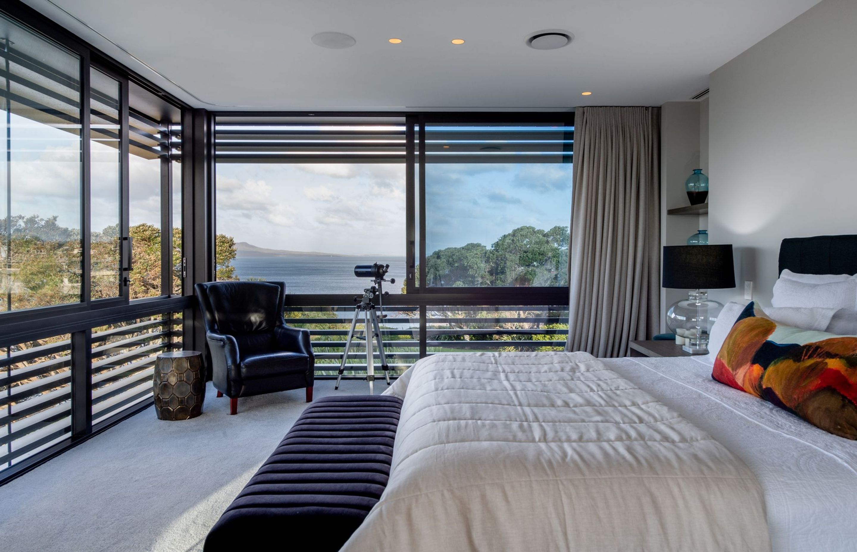 Situated in its 'conservatory-like' glass box, the main bedroom revels in almost 180-degree views of the water.