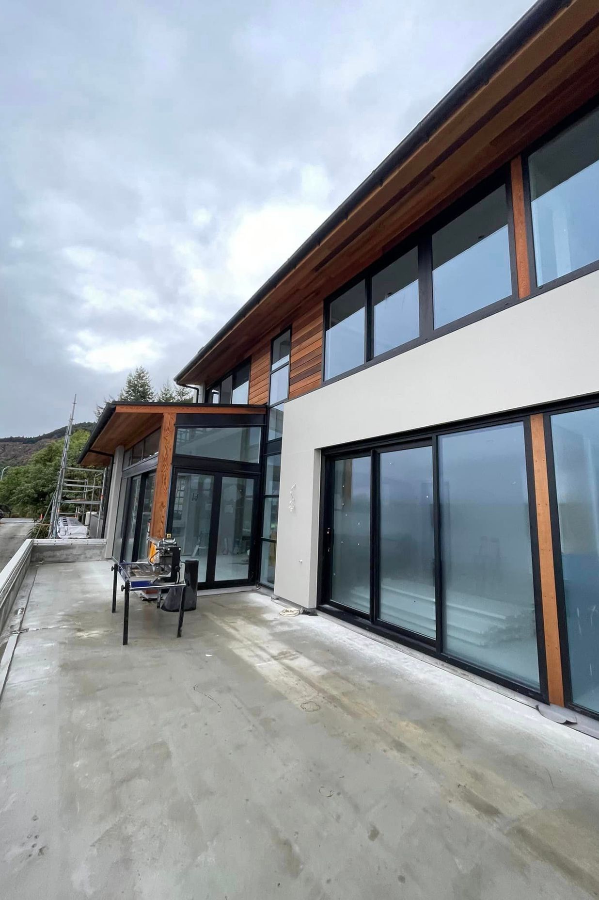 Cladding complete, cedar weatherboards and exterior plaster system in 'Resene - Quarter Arrowtown'