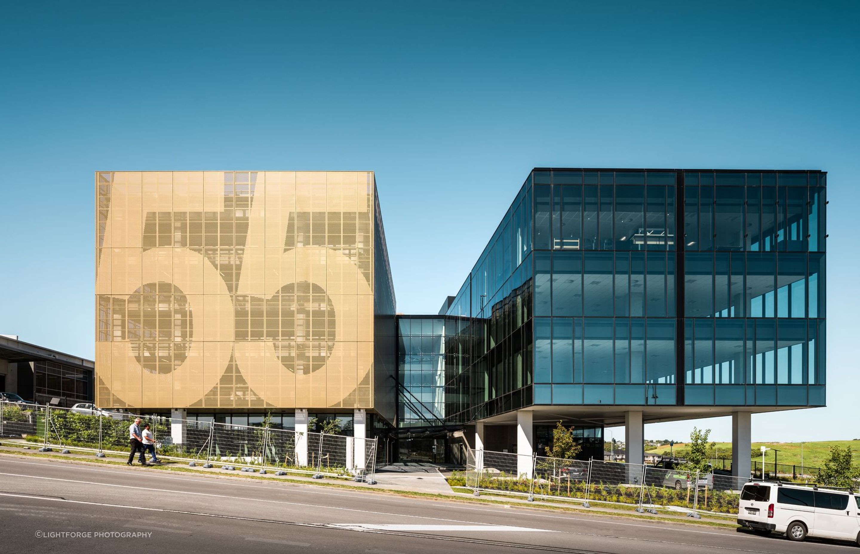 The view from Corinthian Drive showcases the number '55' on the perforated metal screens of the car parking building.