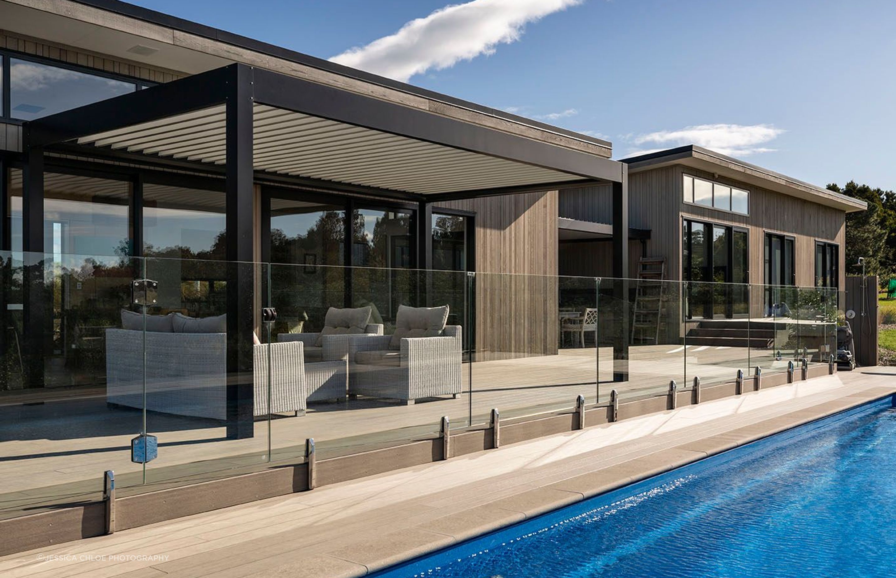 Generous composite decks lead out to the pool from the outdoor entertaining area.
