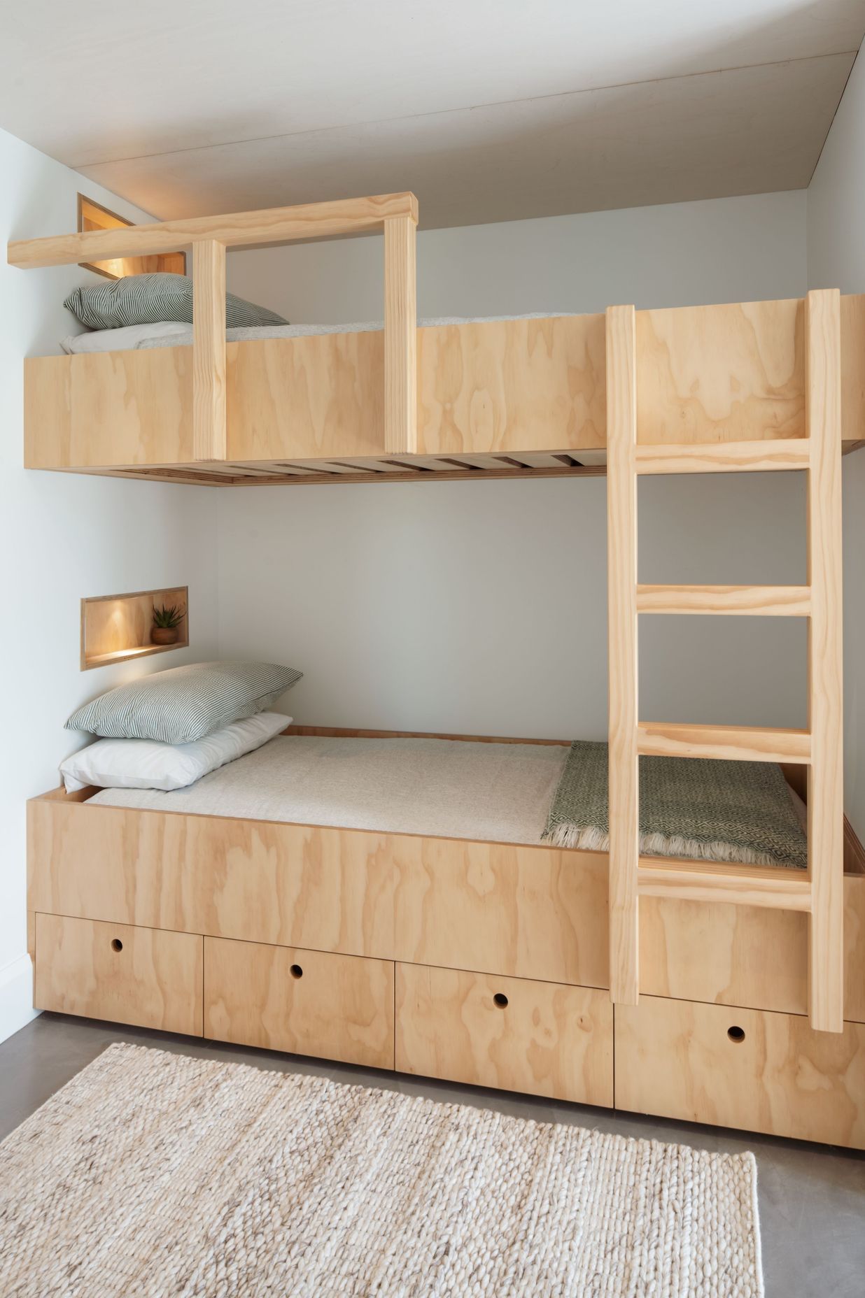Originally designed as a two-bedroom bach, an additional bunk room was added to the design scheme so that the owners' grandchildren could spend time there as well.