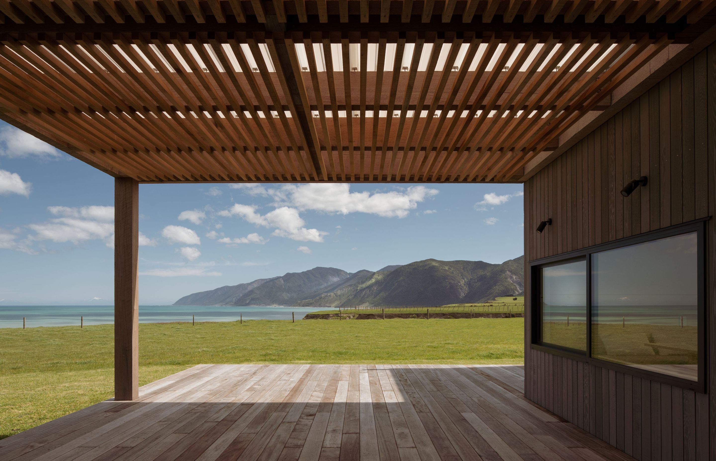 The design of the house needed to be robust enough to withstand the southerly storms that roll in off the Pacific Ocean but warm and inviting enough to allow the owners to take advantage of the natural elements, too.