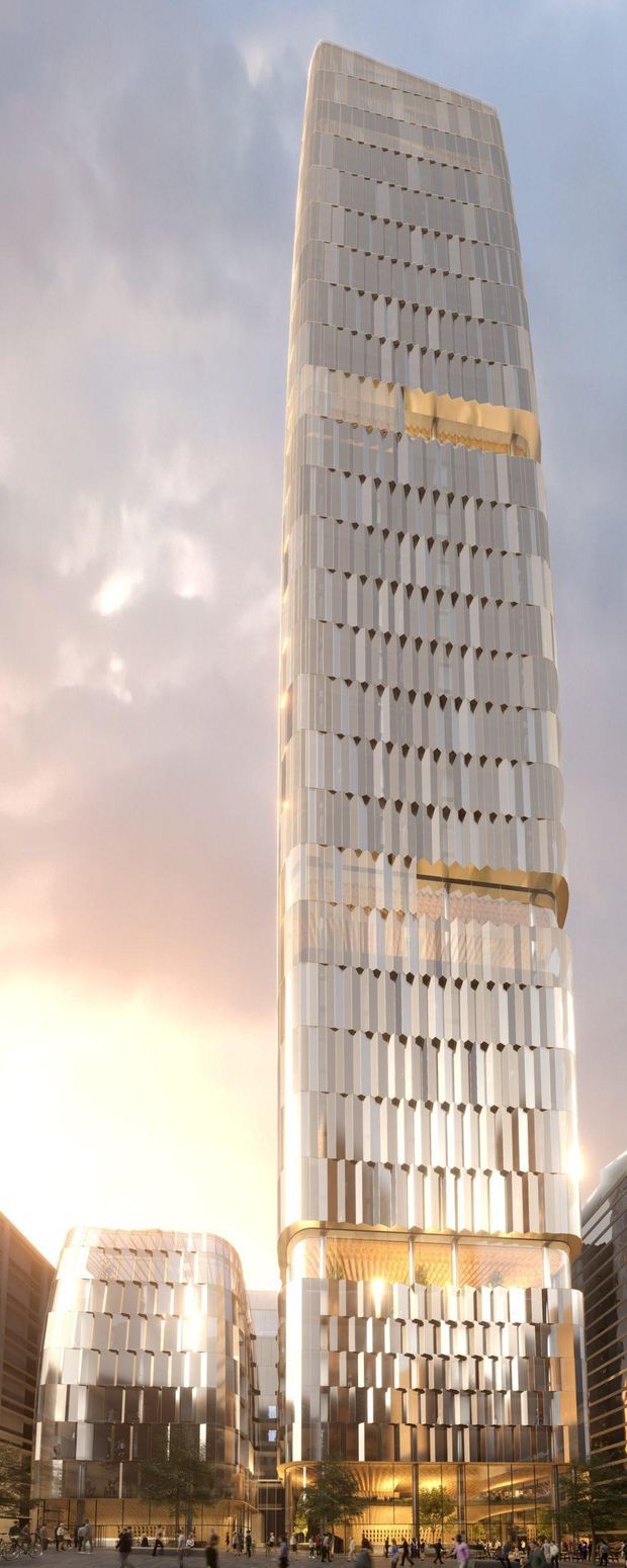 A tall contemporary high-rise tower with rounded corners and a highly articulated glazed facade, featuring repeated vertical fins and projecting geometric shading elements. Warm interior lighting and illuminated podium buildings create a dramatic urban architectural scene at dusk, with a public plaza and smaller adjoining structures at ground level.