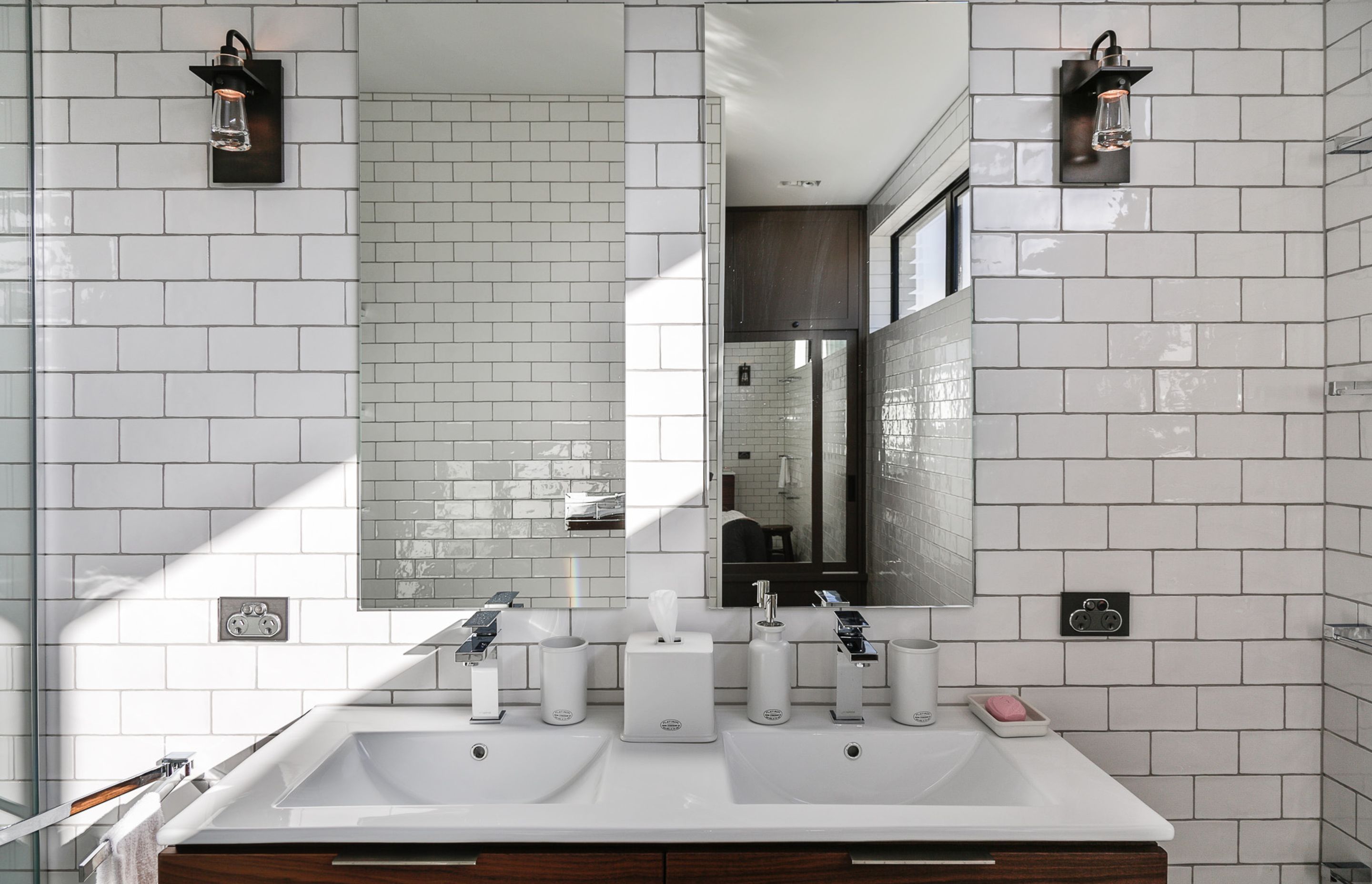Floor-to-ceiling subway tiles in the guest bathroom are a nod to one of the owners' American heritage.