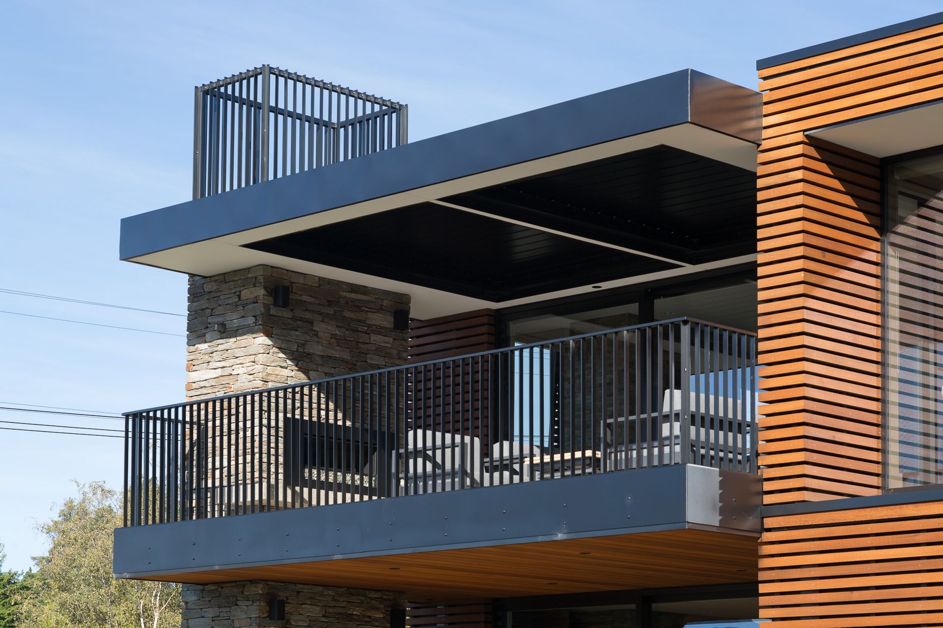 As most of the living is done upstairs, a large, covered balcony provides a sheltered outdoor space that flows from the interior living area.