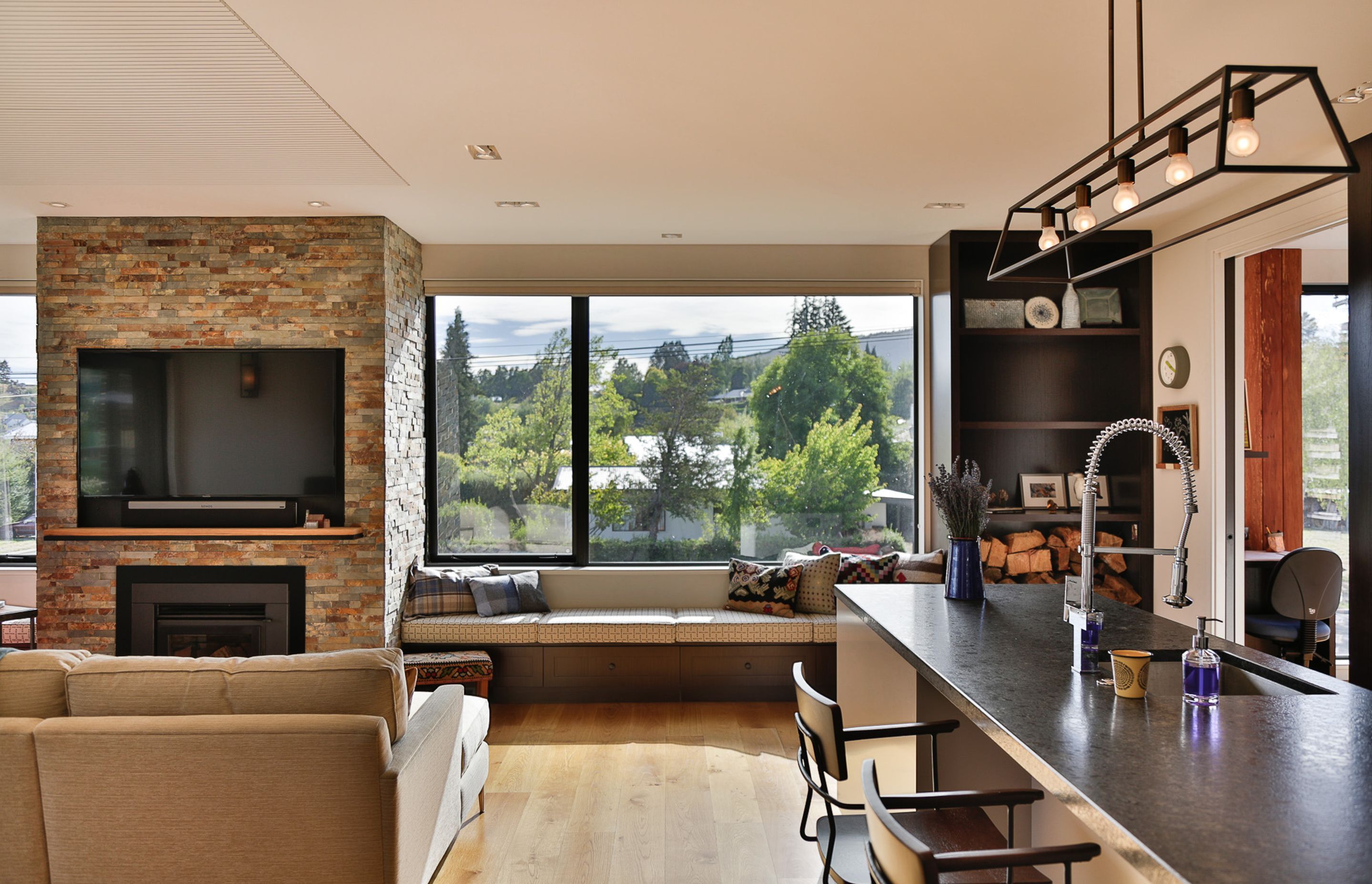 Window seats on either side of the fireplace allow for reflective contemplation of the world outside and also provide additional storage space.