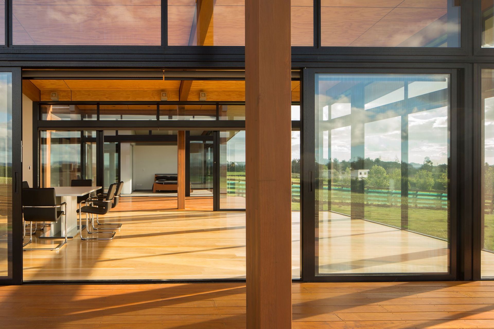 Two pavilions are linked by extensive decking and extensive glazing.