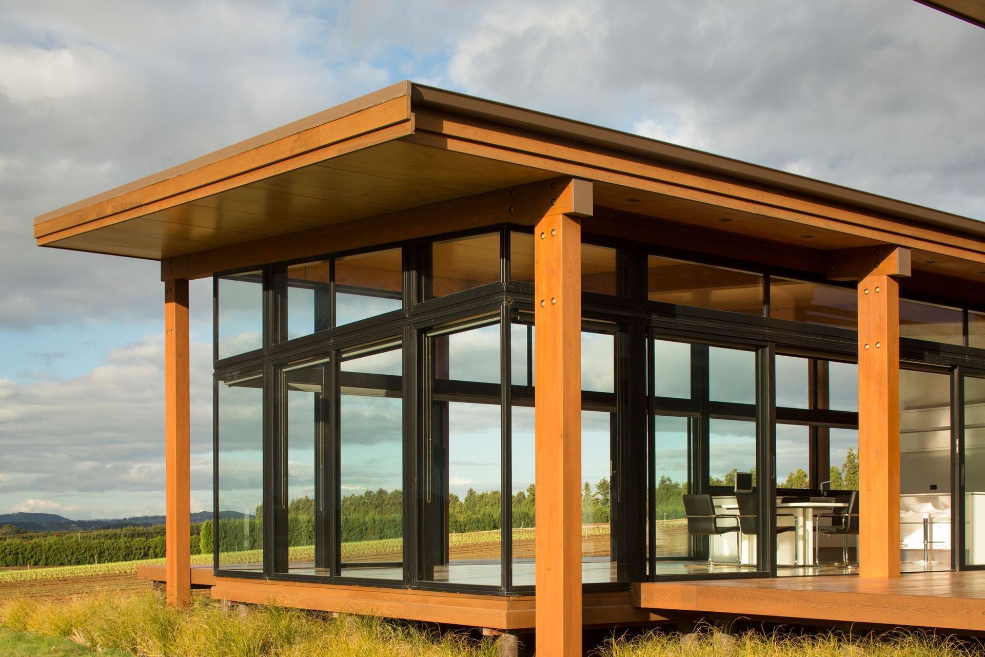 Generous overhangs provide shade while ample opening doors create cross ventilation for passive cooling.