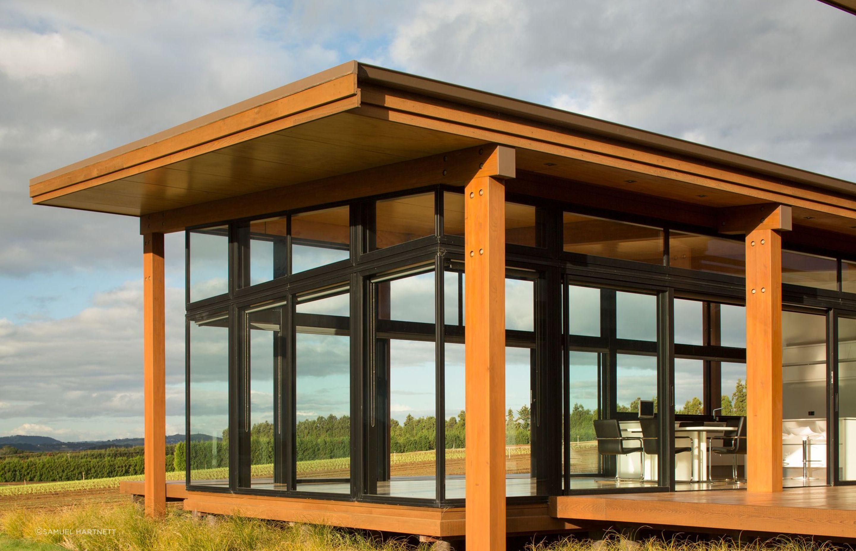 Generous overhangs provide shade while ample opening doors create cross ventilation for passive cooling.
