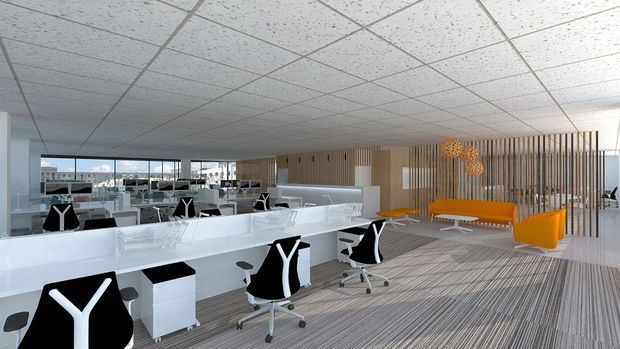Bright open-plan commercial office interior with rows of white workstations and black-and-white ergonomic office chairs. Full-height glazing and mirrors/reflections extend the workspace visually, while a timber slatted partition separates a lounge area furnished with vivid orange seating and pendant lights. The space has a suspended acoustic tile ceiling and striped carpet flooring.