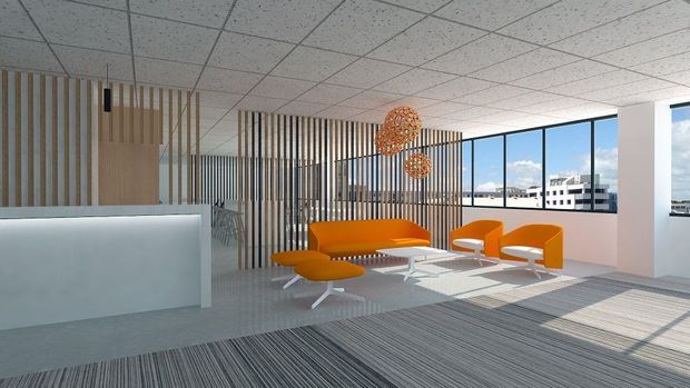 A bright contemporary commercial lounge or reception area with an orange sofa, lounge chairs, and ottoman arranged around a low coffee table. Vertical timber slat screens divide the space, while large windows provide abundant daylight and city views. The room has a suspended acoustic tile ceiling, patterned carpet flooring, a pale reception counter, and sculptural woven pendant lights.