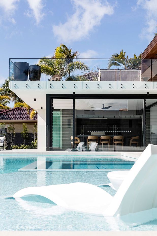 Sleek glass walls throughout the home frame captivating views of the water, providing further indication that Minyama’s main priority is the mingling of indoor-outdoor living.