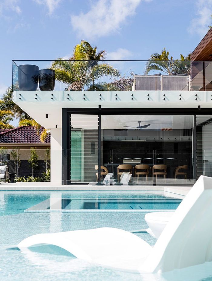 Sleek glass walls throughout the home frame captivating views of the water, providing further indication that Minyama’s main priority is the mingling of indoor-outdoor living.