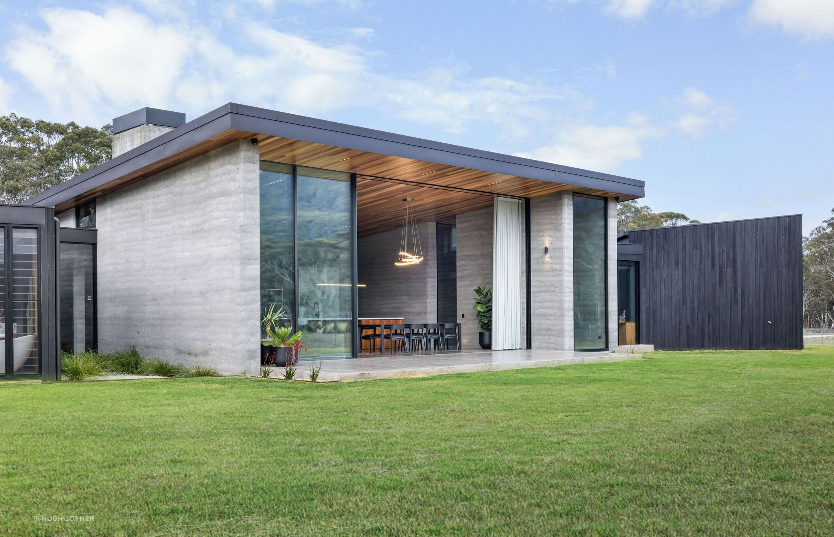 The position of a glass facade and entrance foyer frames the escarpment in a way that captivates the viewer and draws you in.