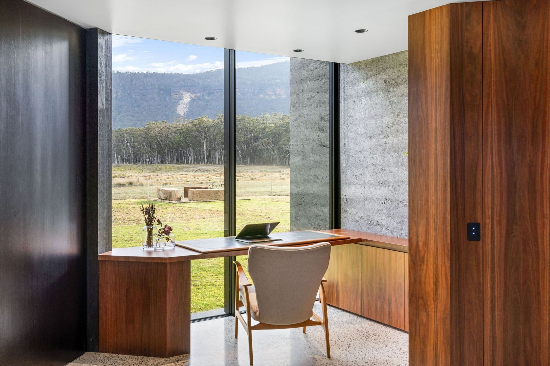 An intimate gallery area creates a smooth transition to a more private segment of the home, providing a space where the owners can look out to a framed view of the exterior, relax and reflect on the sheer beauty of it all.