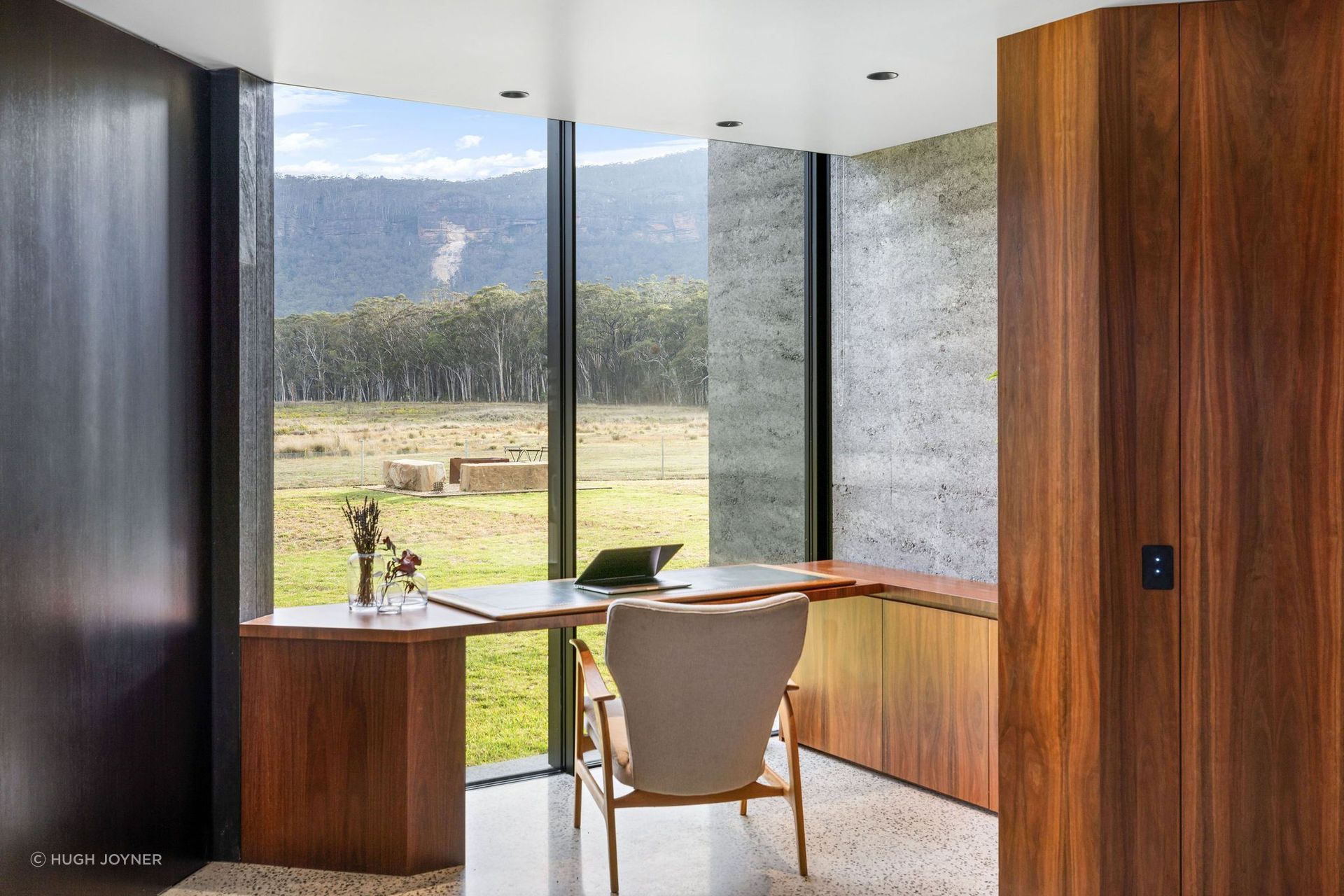 An intimate gallery area creates a smooth transition to a more private segment of the home, providing a space where the owners can look out to a framed view of the exterior, relax and reflect on the sheer beauty of it all.