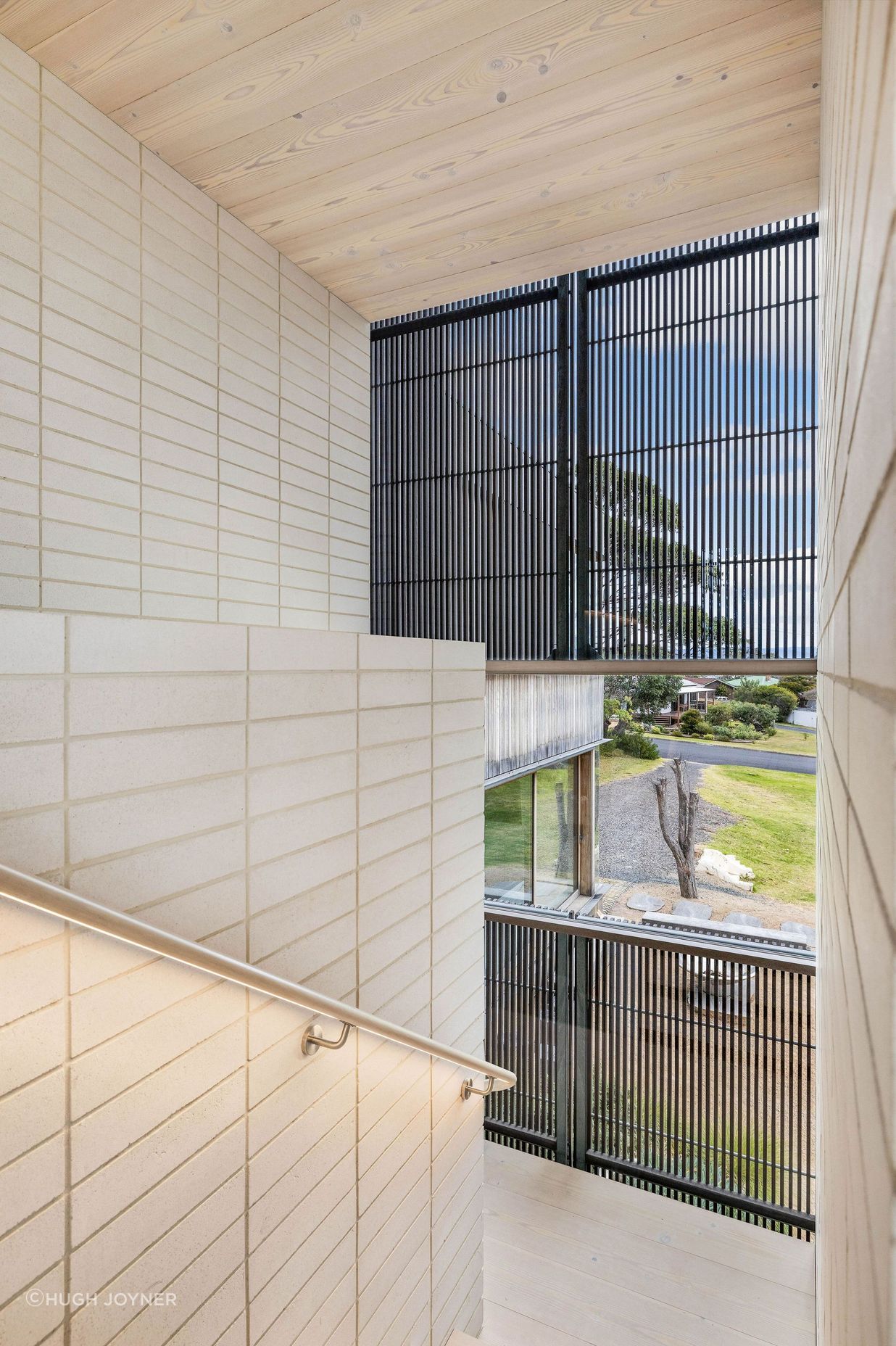The space is enhanced by the soft, muted palette of whites, creams, sand tones and light timbers.